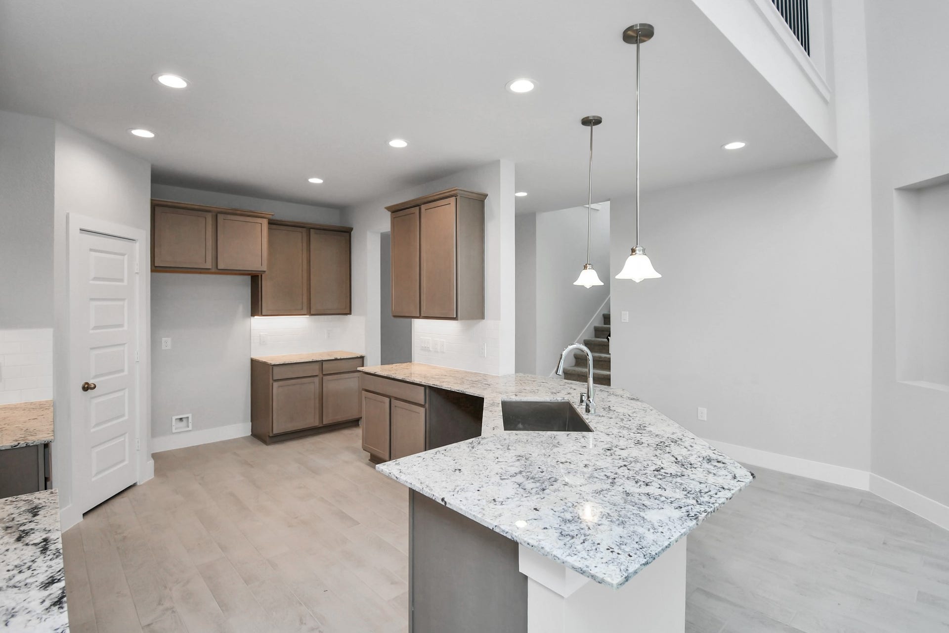 All of this overlooks your expansive family room, creating a perfect space for culinary delights and family gatherings. Sample photo of completed home with similar floor plan. Actual colors and selections may vary.