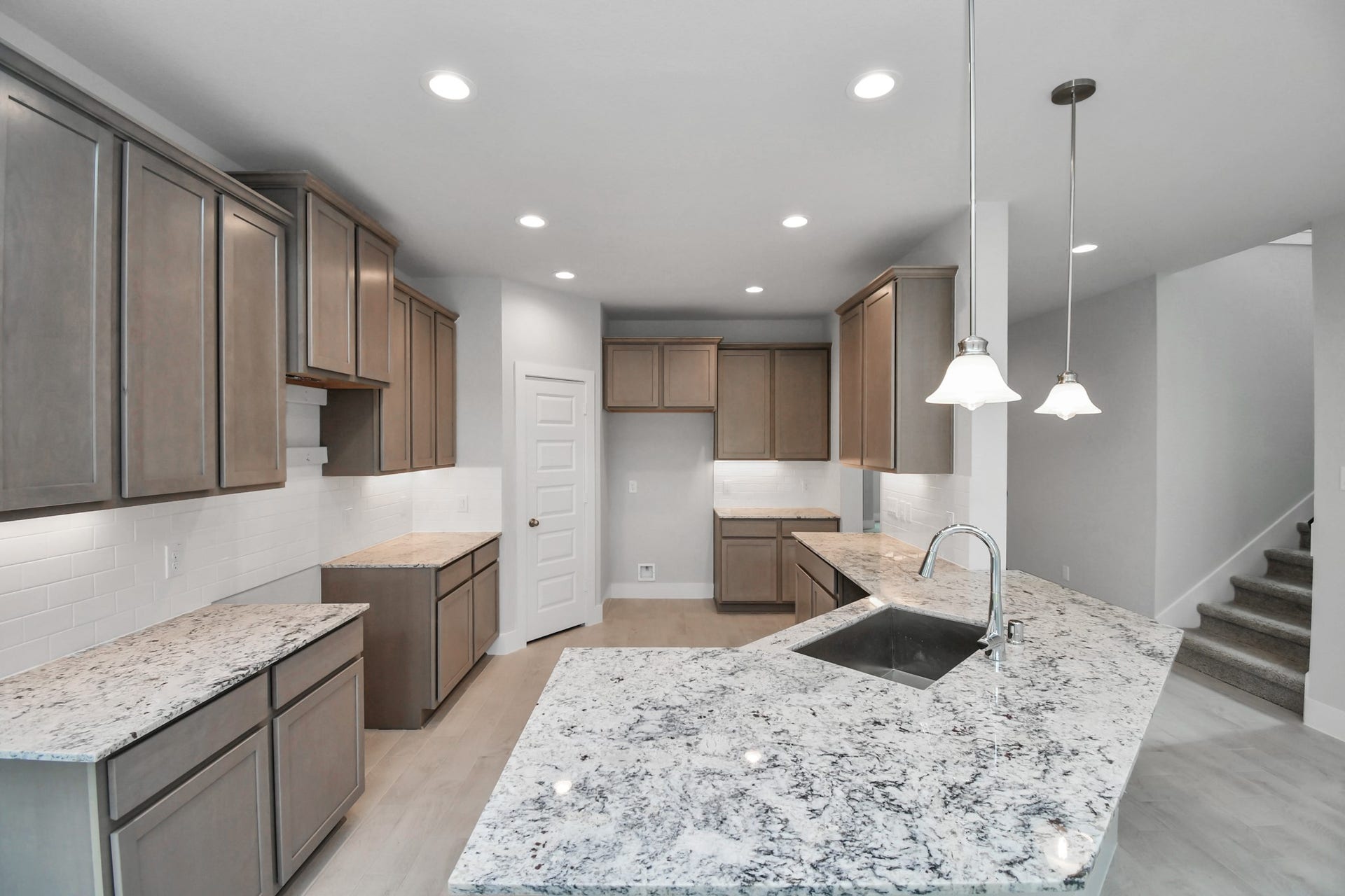 The open concept effortlessly connects the kitchen to the expansive family room, forming a perfect hub for gatherings. This seamless flow creates an inviting space where cooking and socializing come together harmoniously. Sample photo of completed home with similar floor plan. Actual colors and selections may vary.