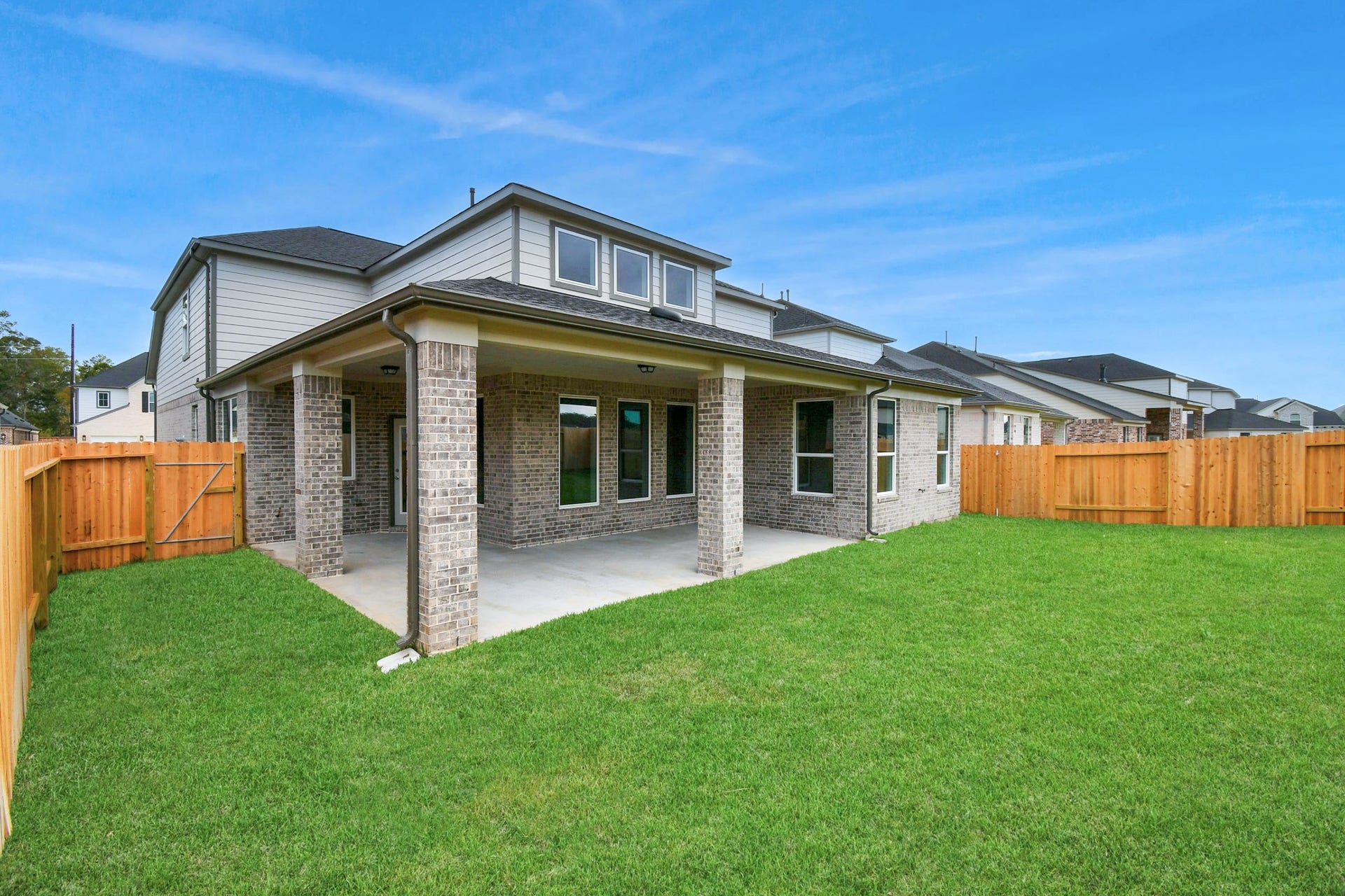Come and see this spacious backyard with its beautiful covered patio. There is plenty of room for the kids to play and adults to relax. Perfect for your outdoor living space, patio furniture, bbq pit, and so much more. The possibilities are endless! Sample photo of completed home with similar floor plan. Actual colors and selections may vary.