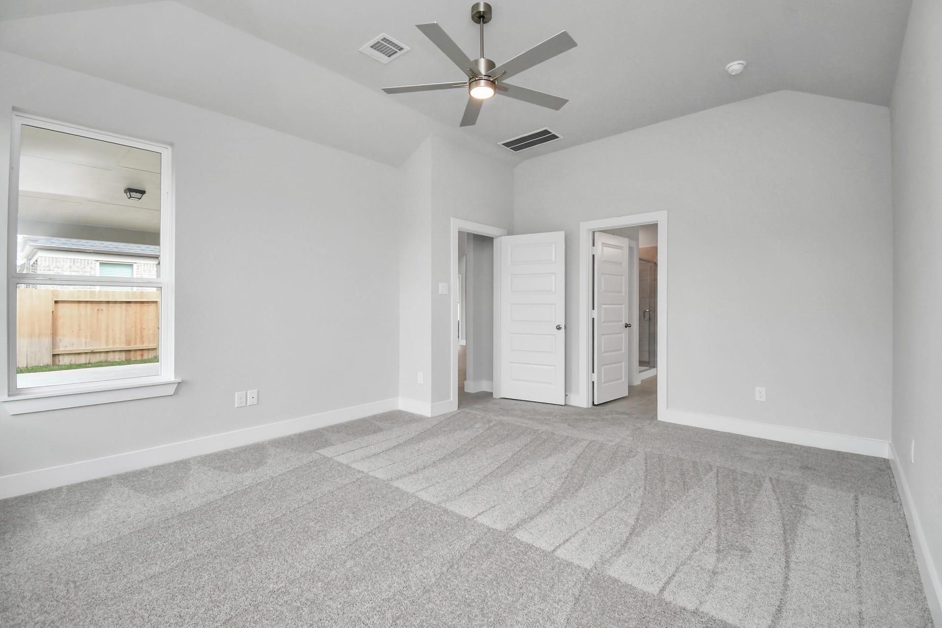 Come and unwind after a long day in this magnificent primary suite! This spacious room features plush carpet, warm paint, high ceilings and large windows with privacy blinds. Sample photo of completed home with similar floor plan. Actual colors and selections may vary.