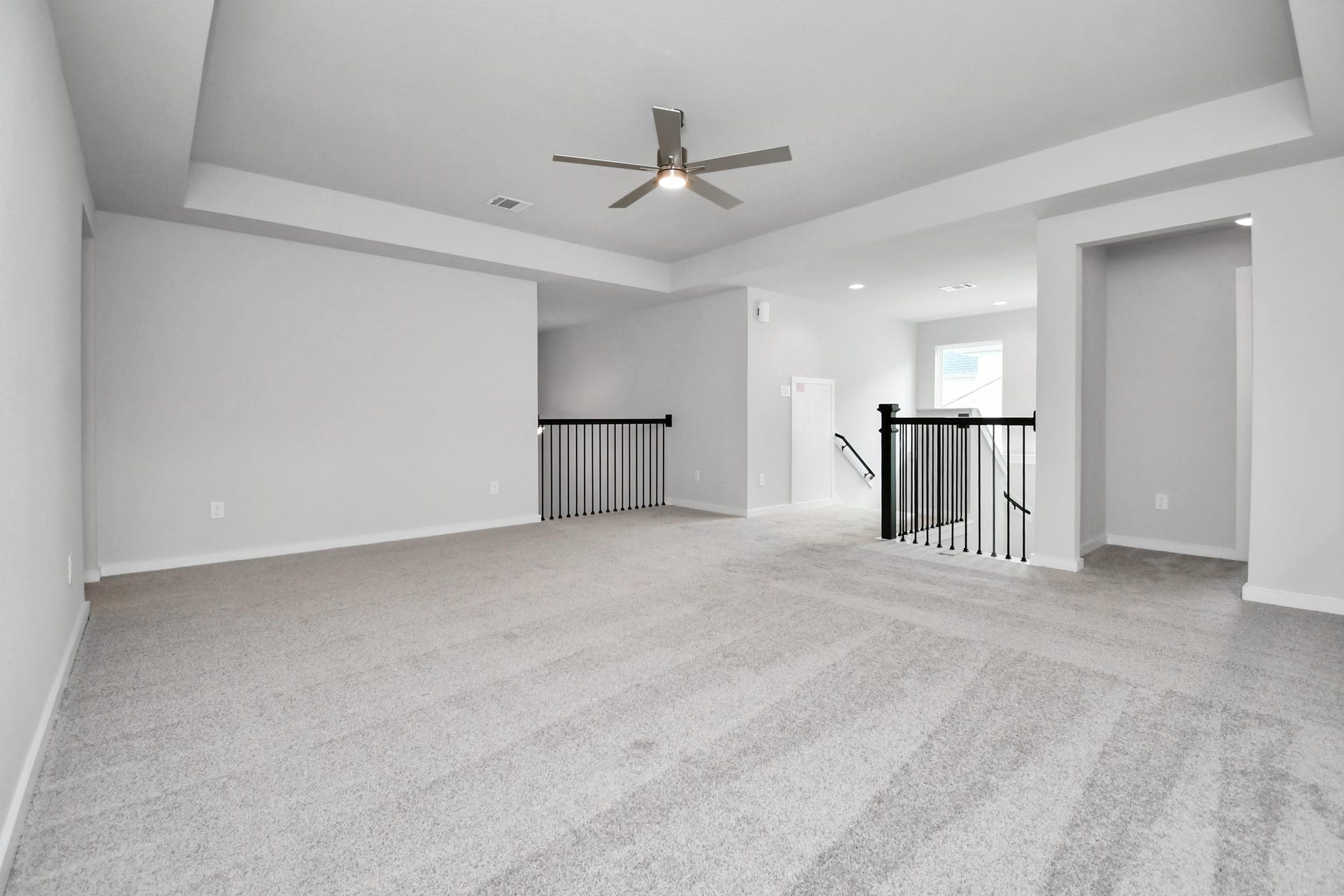 Come upstairs and enjoy a day of leisure in this fabulous game room! This is the perfect hangout spot or adult game room! Features plush carpet, high ceilings, custom paint and windows for plenty of natural light. Sample photo of completed home with similar floor plan. Actual colors and selections may vary.