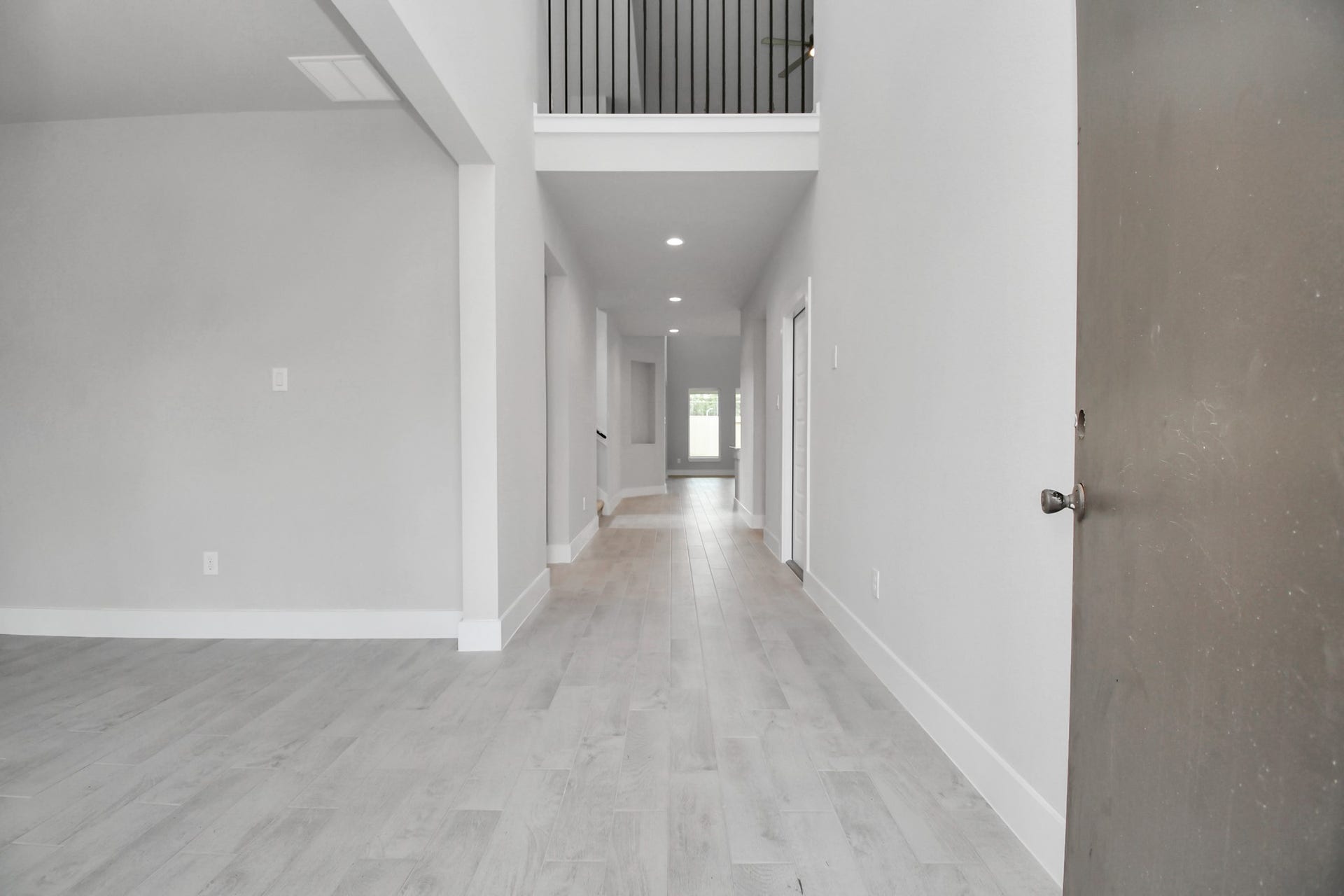 As you step into the threshold of this luxurious home, you'll soon be welcomed by an elegant glass door (to be installed). Inside, soaring ceilings amplify the spaciousness, while the refined wood-look tile flooring and oversized baseboards exude sophistication and charm. Sample photo of completed home with similar floor plan. Actual colors and selections may vary.