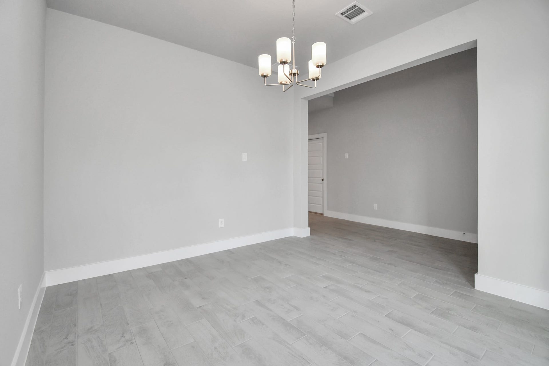 Craft enduring memories with loved ones around the table! This roomy dining area boasts stylish flooring, personalized paint, and is conveniently situated next to the family room and kitchen, fostering an open and inclusive ambiance. Sample photo of completed home with similar floor plan. Actual colors and selections may vary.