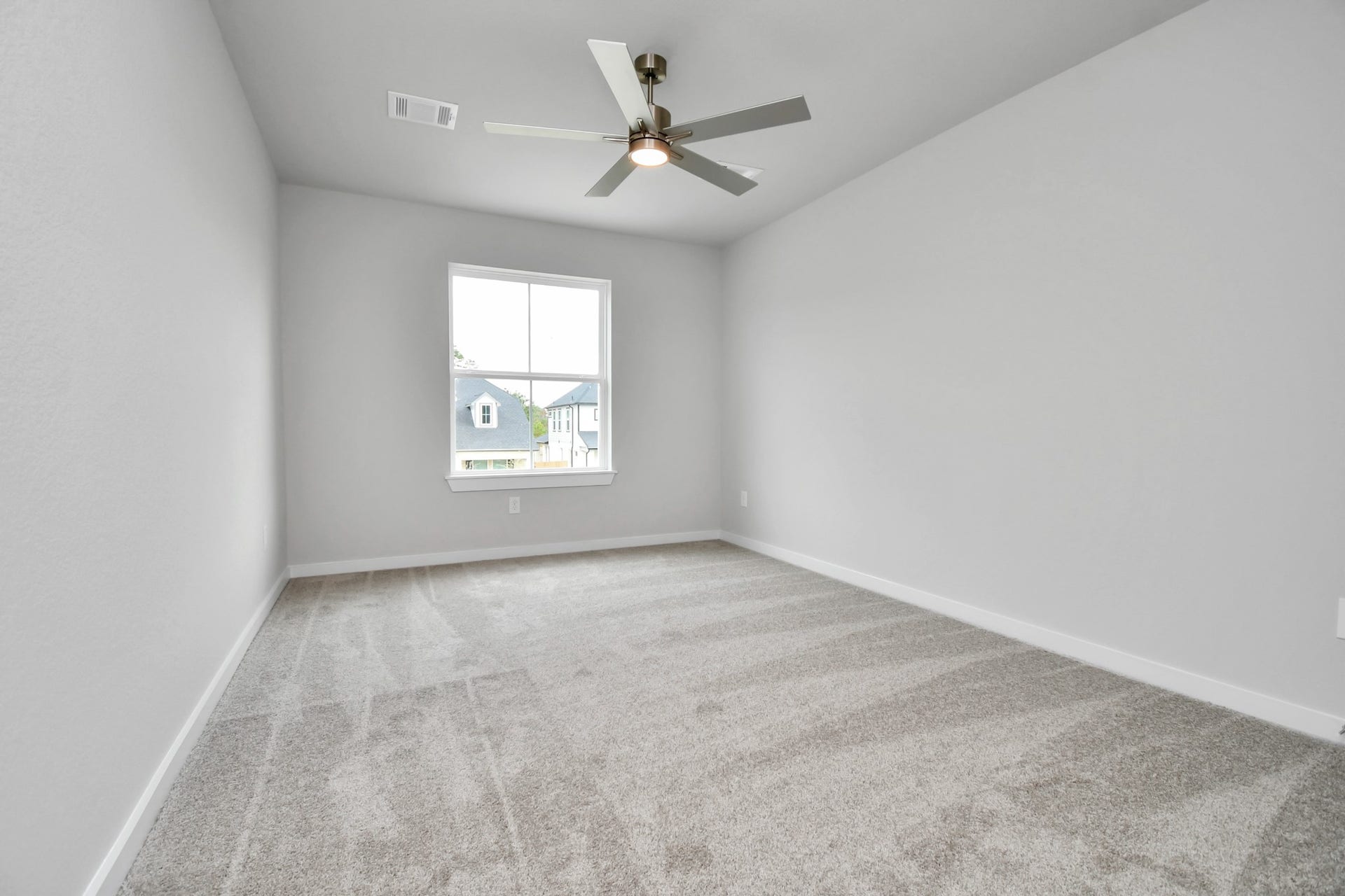 Secondary bedroom features plush carpeting, large windows that let in plenty of natural light, bright paint, and spacious closets. Sample photo of completed home with similar floor plan. Actual colors and selections may vary.