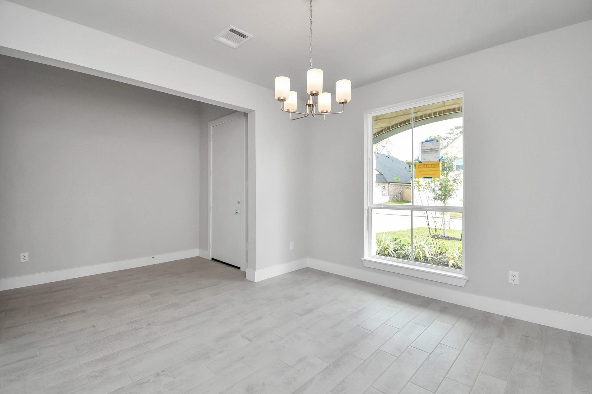 Make memories gathered around the table with your family and friends! This spacious dining room features elegant flooring, custom paint, and adjacent to family room and kitchen for open concept feel. Sample photo of completed home with similar floor plan. Actual colors and selections may vary.