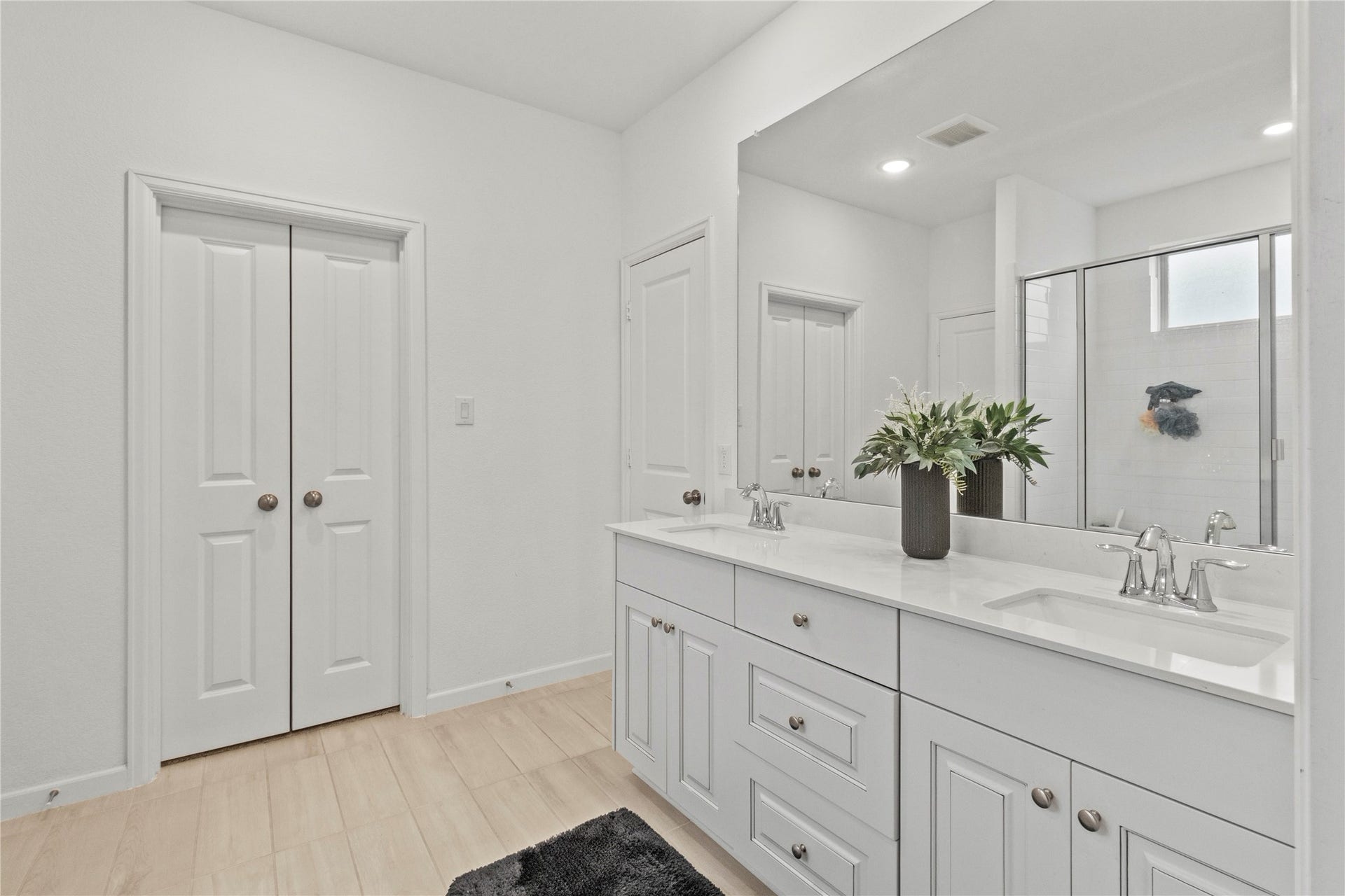2909 Ballast Green Drive, La Marque, TX 77568 Bright and spacious bathroom featuring a double vanity with sleek countertops, ample storage, and a modern shower area for a luxurious feel.