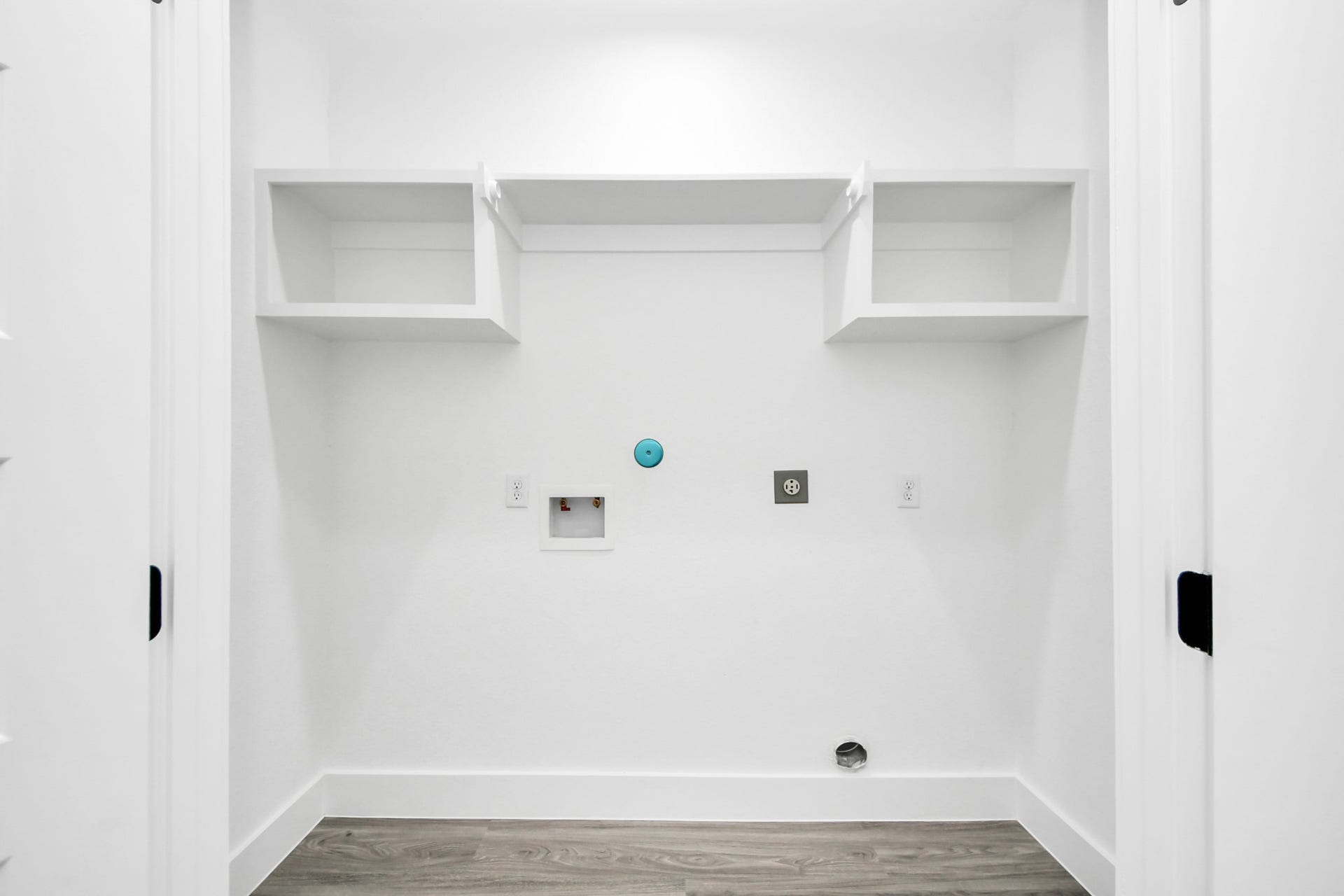 6711 Crestmont Street, Houston, TX 77033 A spacious, well-lit laundry area with built-in shelving and modern hookups, ready for your appliances.