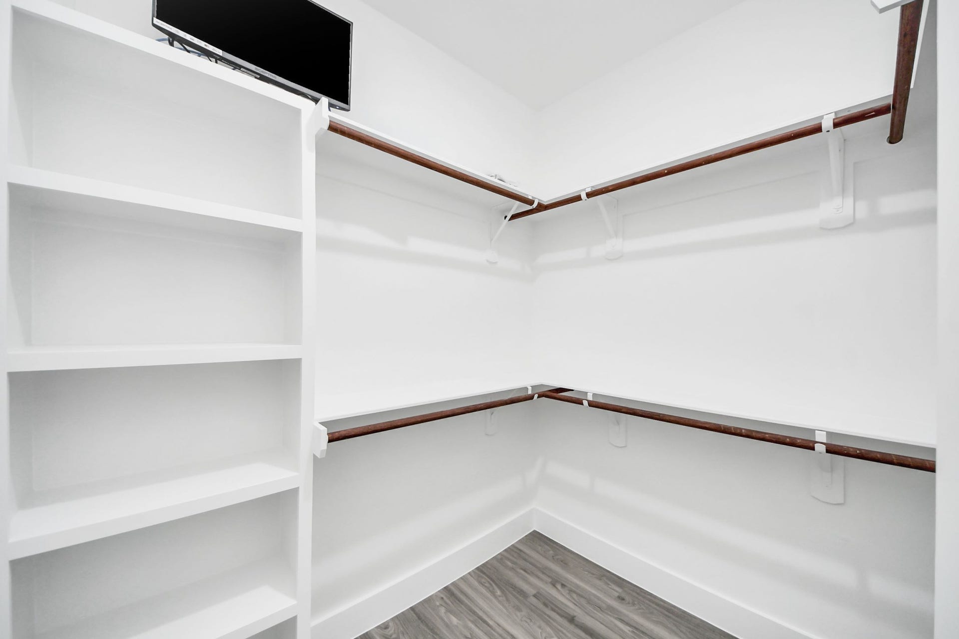 6711 Crestmont Street, Houston, TX 77033 Spacious walk-in closet featuring built-in shelving and ample hanging space, perfect for organized storage.