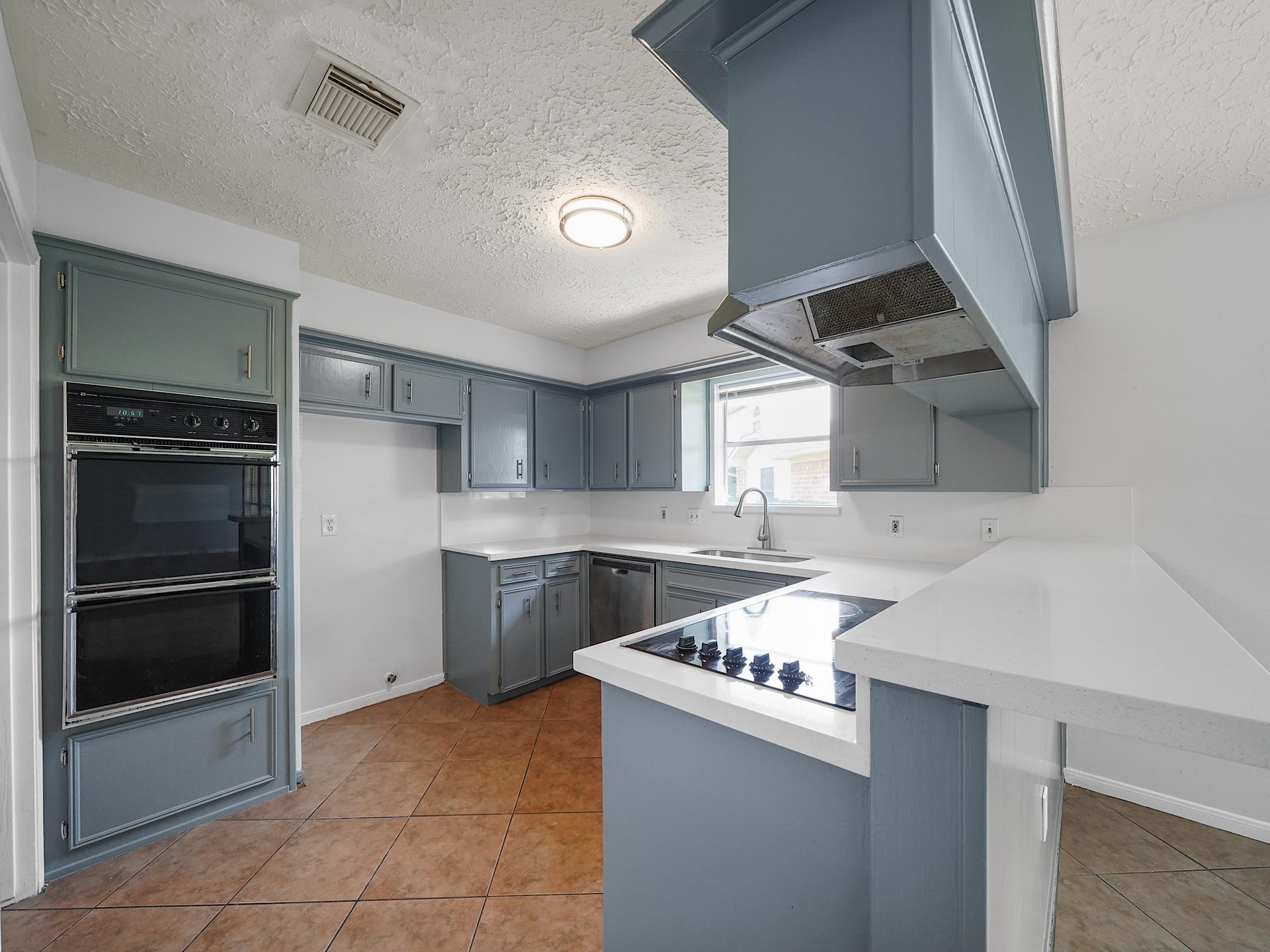 48 Chapparal Court, Missouri City, TX 77459 New Corian Counter Tops, Freshly Painted Cabinets, Double Oven, Electric Cook Top, New Light and Tile Floors