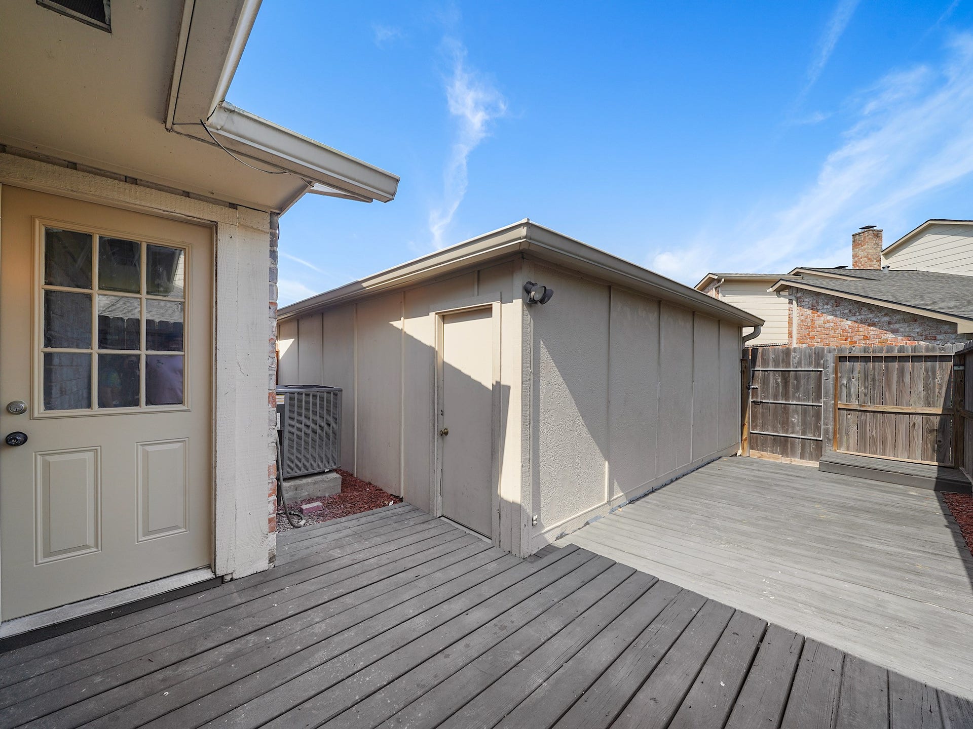 48 Chapparal Court, Missouri City, TX 77459 Detached garage with a patio / deck to relax on.