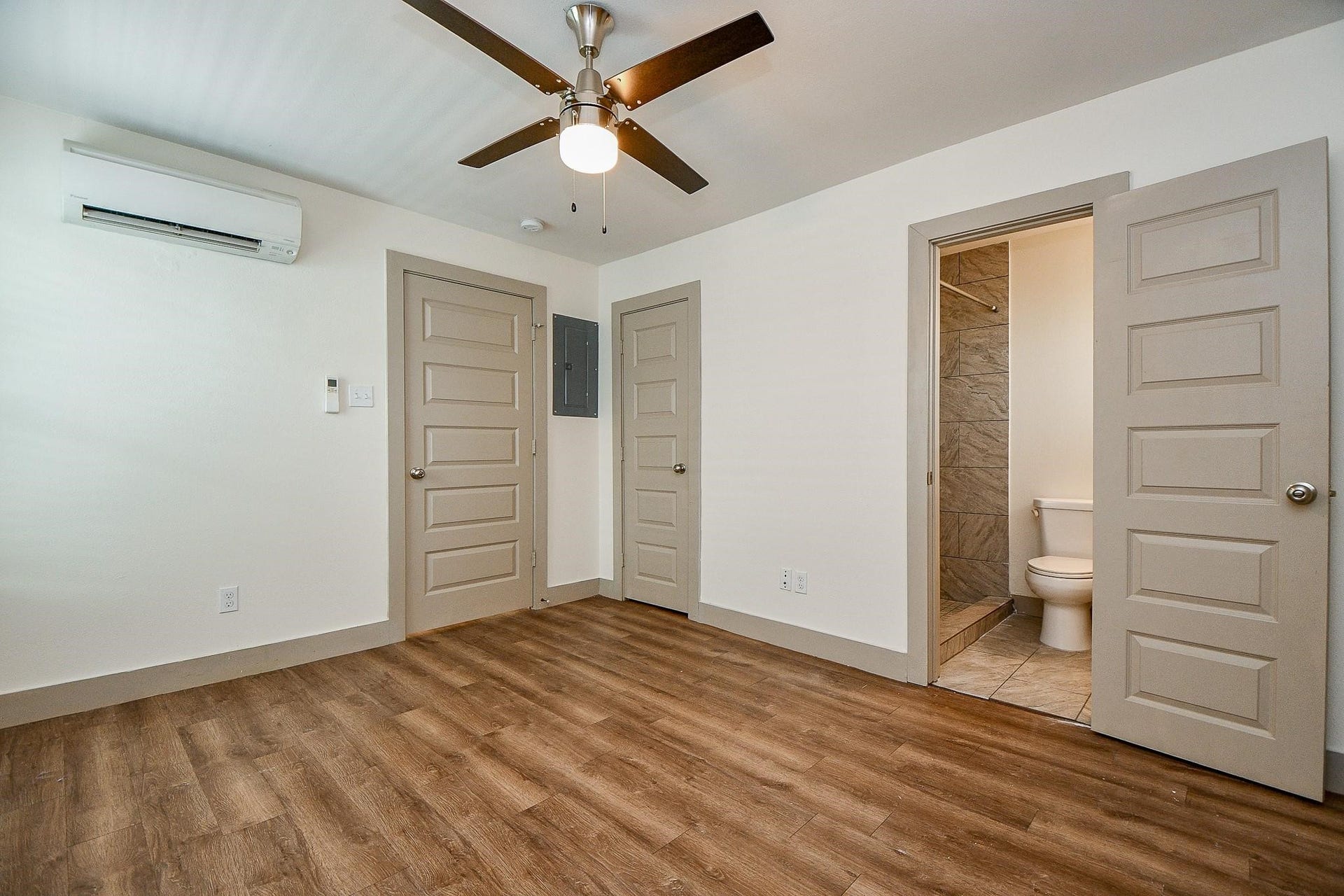 Bedroom with a functional walk-in closet and attached bathroom.
