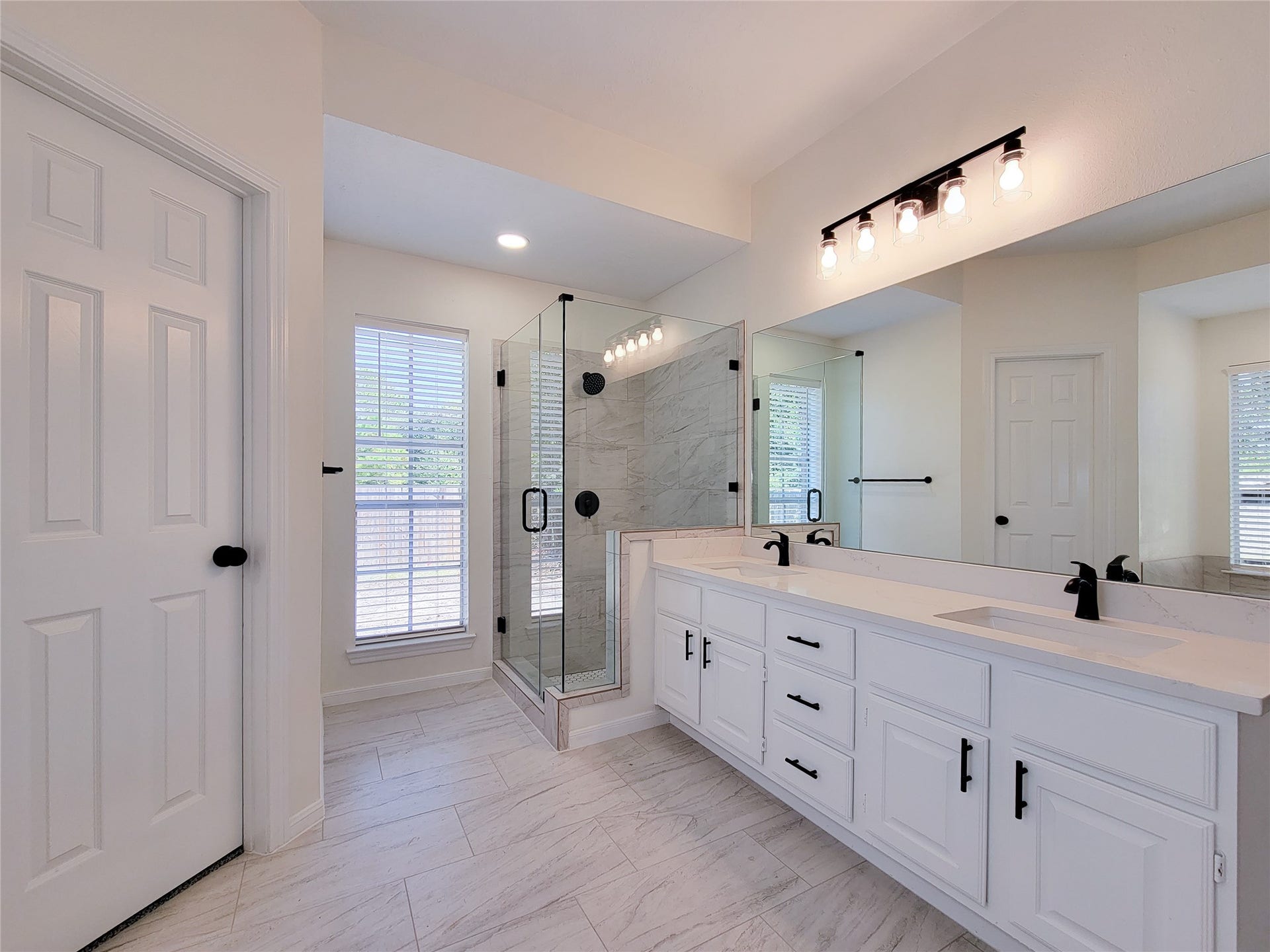 1422 Mabry Mill Road, Houston, TX 77062 Remodeled primary bathroom with quarts counters, a glass-enclosed tiled shower, two closets, private toilet area, and additional storage