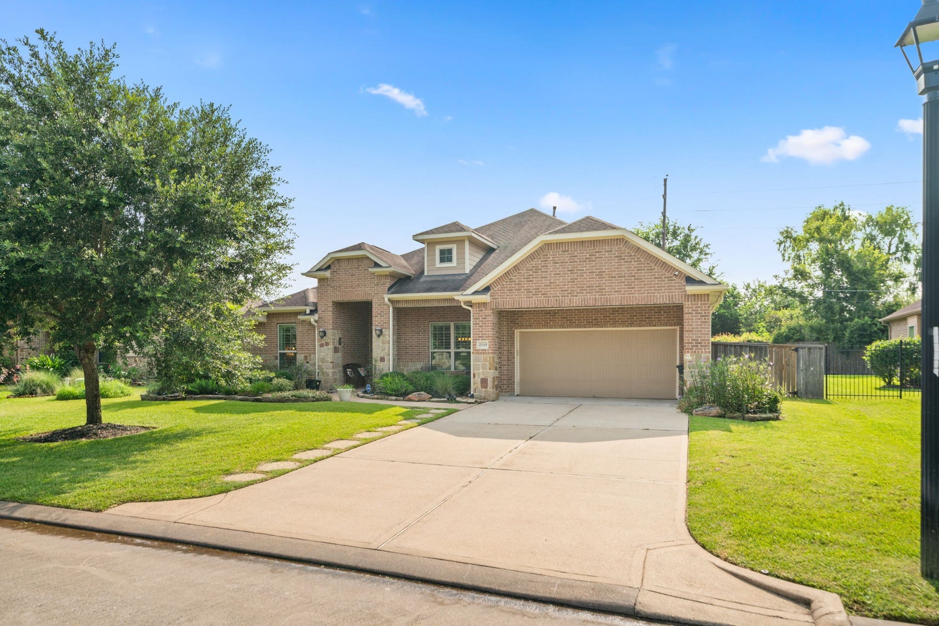32219 Waterford Crest Lane, Fulshear, TX 77441 Charming Brick & Stone Home with a Spacious Driveway leading to a 3 Car attached Tandem Garage
