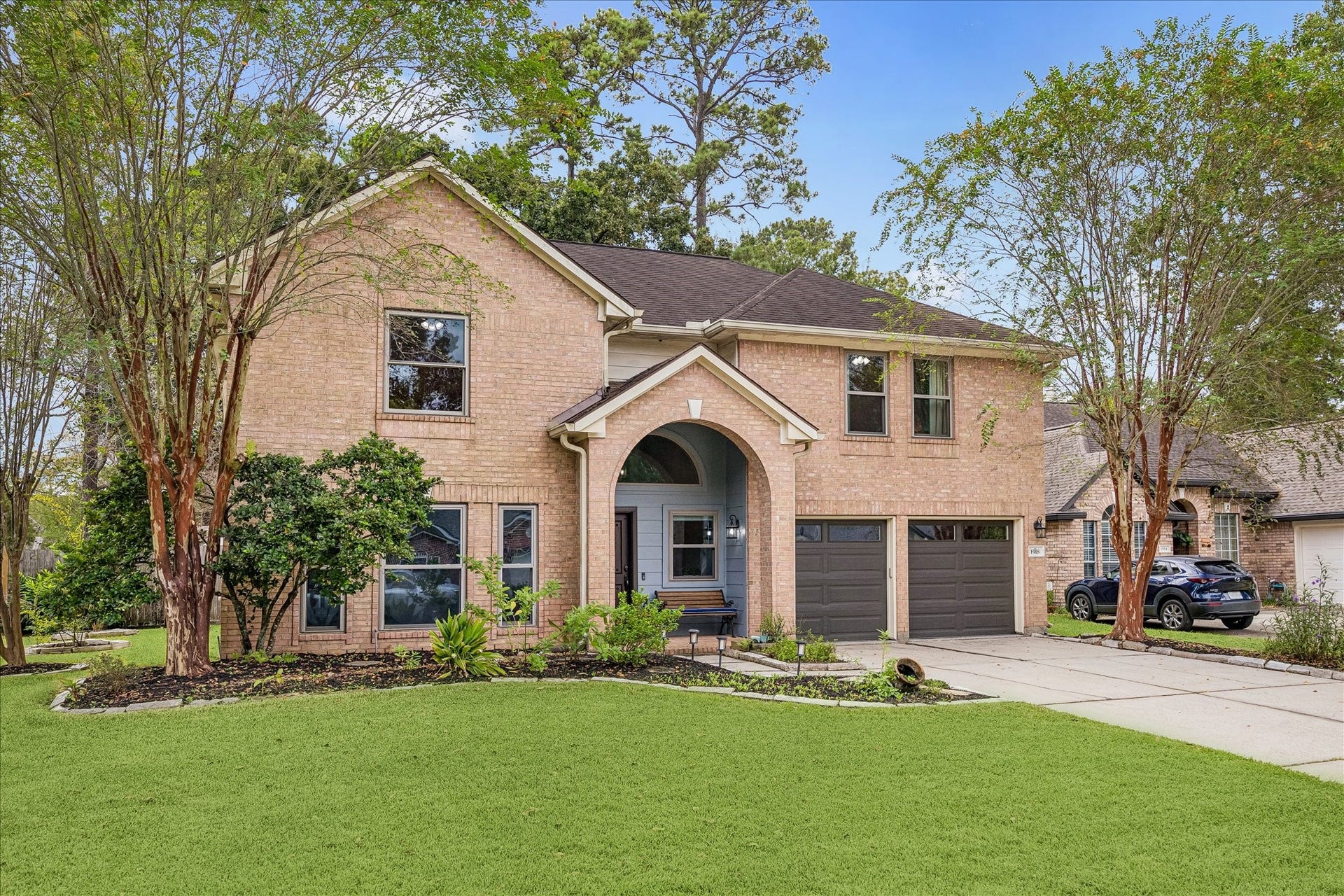 1918 Mercoal Drive, Spring, TX 77386 Front yard with landscaping and covered porch