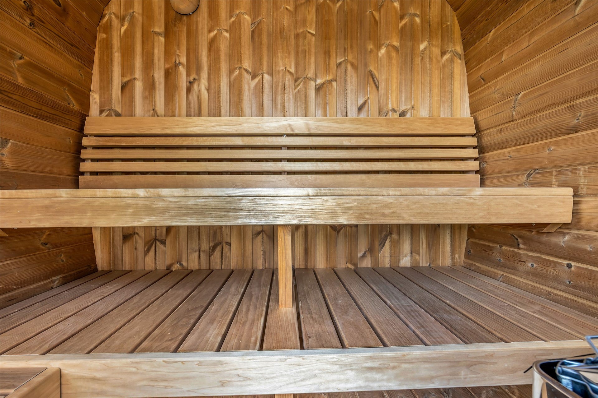 22420 Meadowhurst Circle W, Tomball, TX 77377 This photo features a cozy, wooden sauna with tiered bench seating, offering a warm and inviting space for relaxation.
