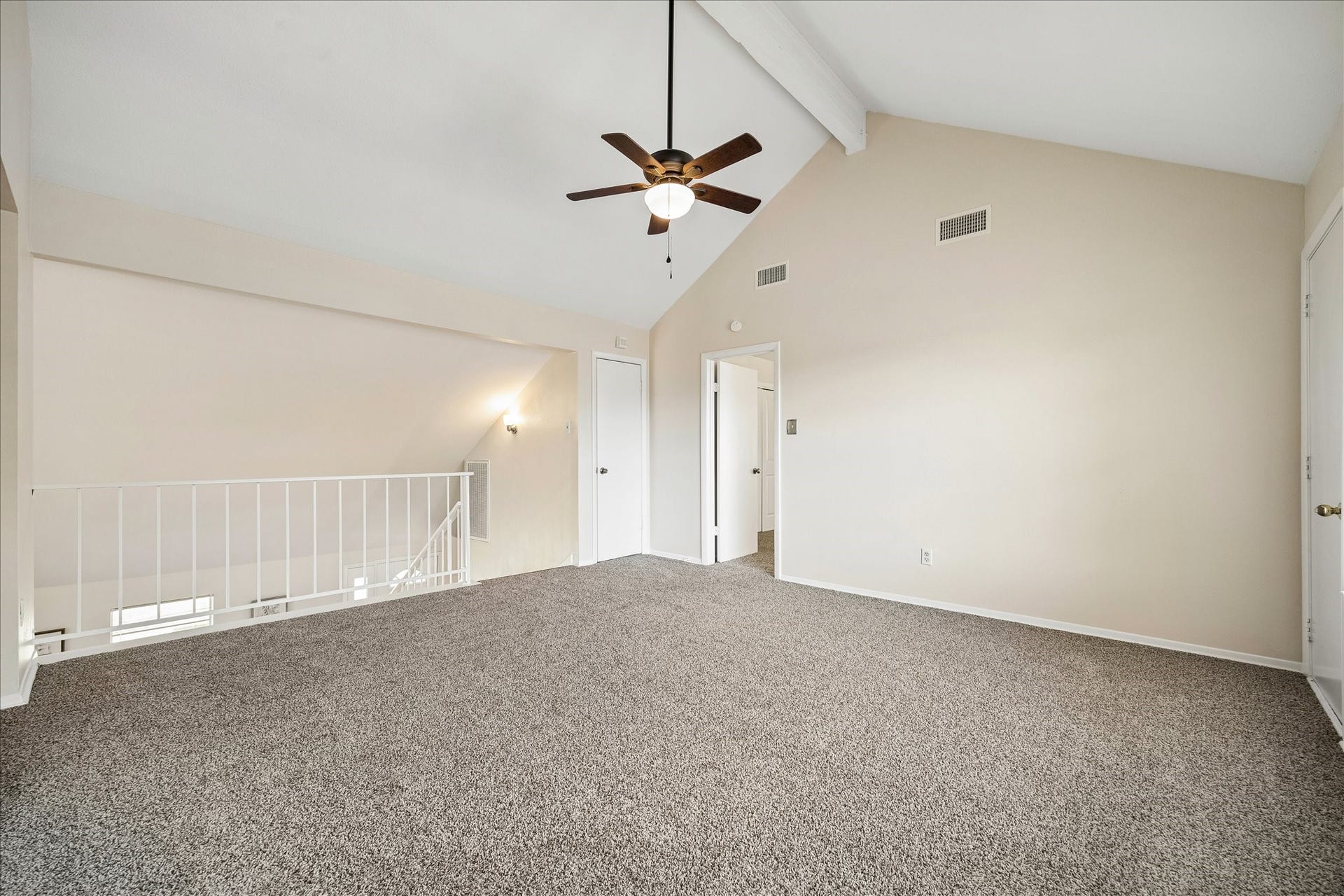 The game room opens to the living room below and also has access to an outdoor balcony. The vaulted ceilings and natural light make this second living area a favorite spot.
