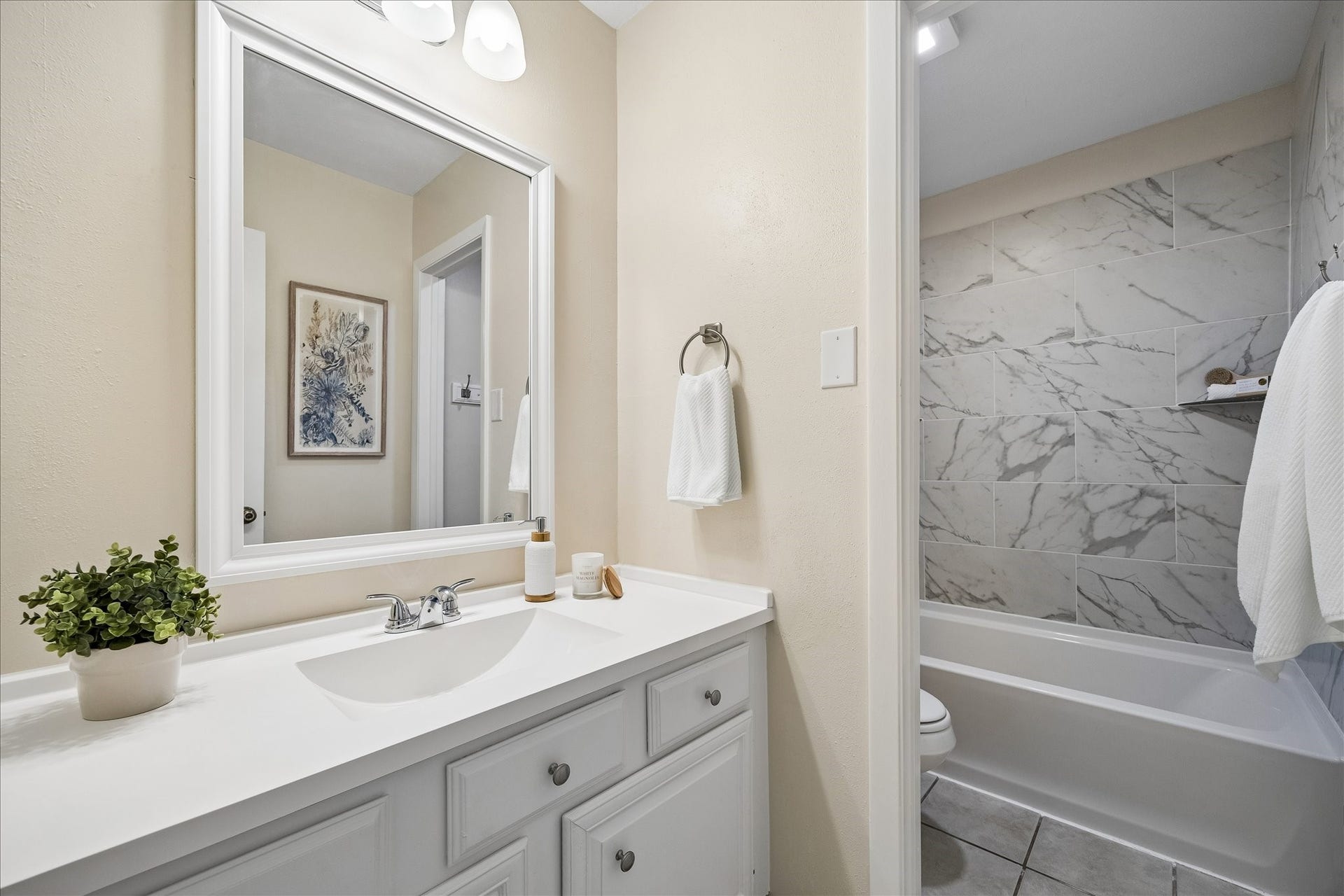 The recently renovated full upstairs bath with tub and shower combined.