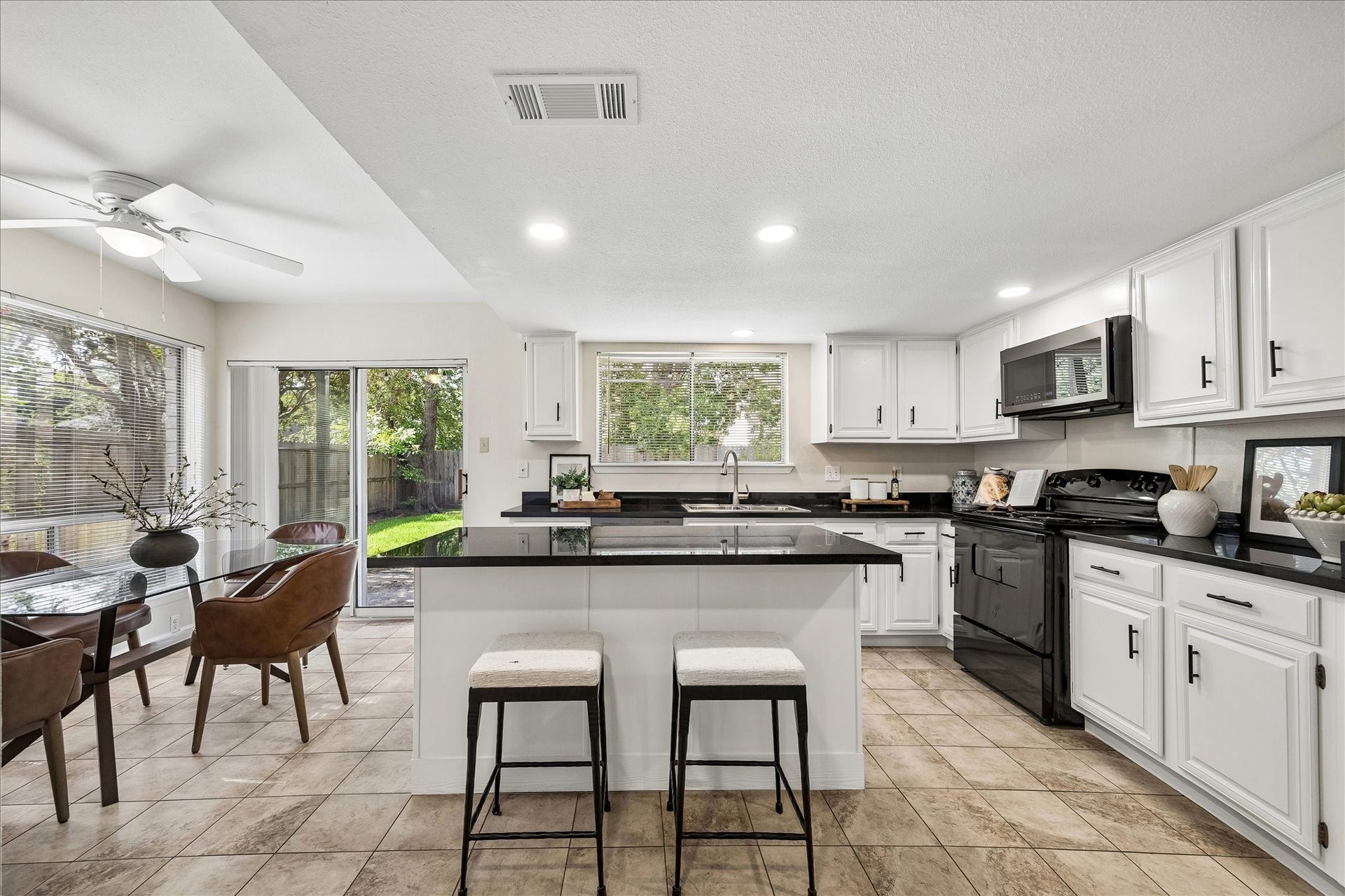 For more casual dining, consider the dining area and island in the kitchen which looks out onto the back yard.