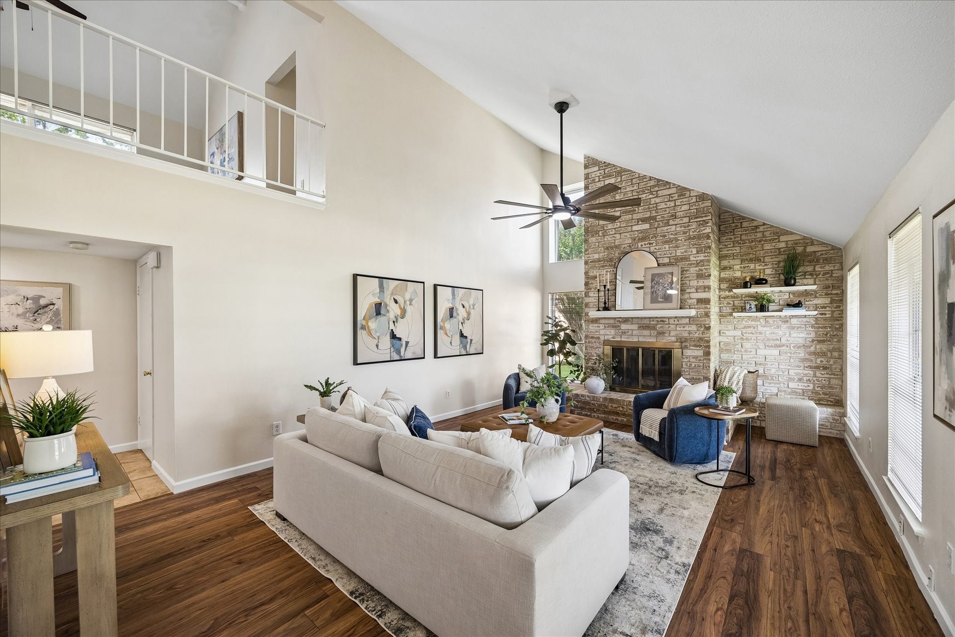 The wood burning fireplace anchors the living area. The second floor game room overlooks the living area.