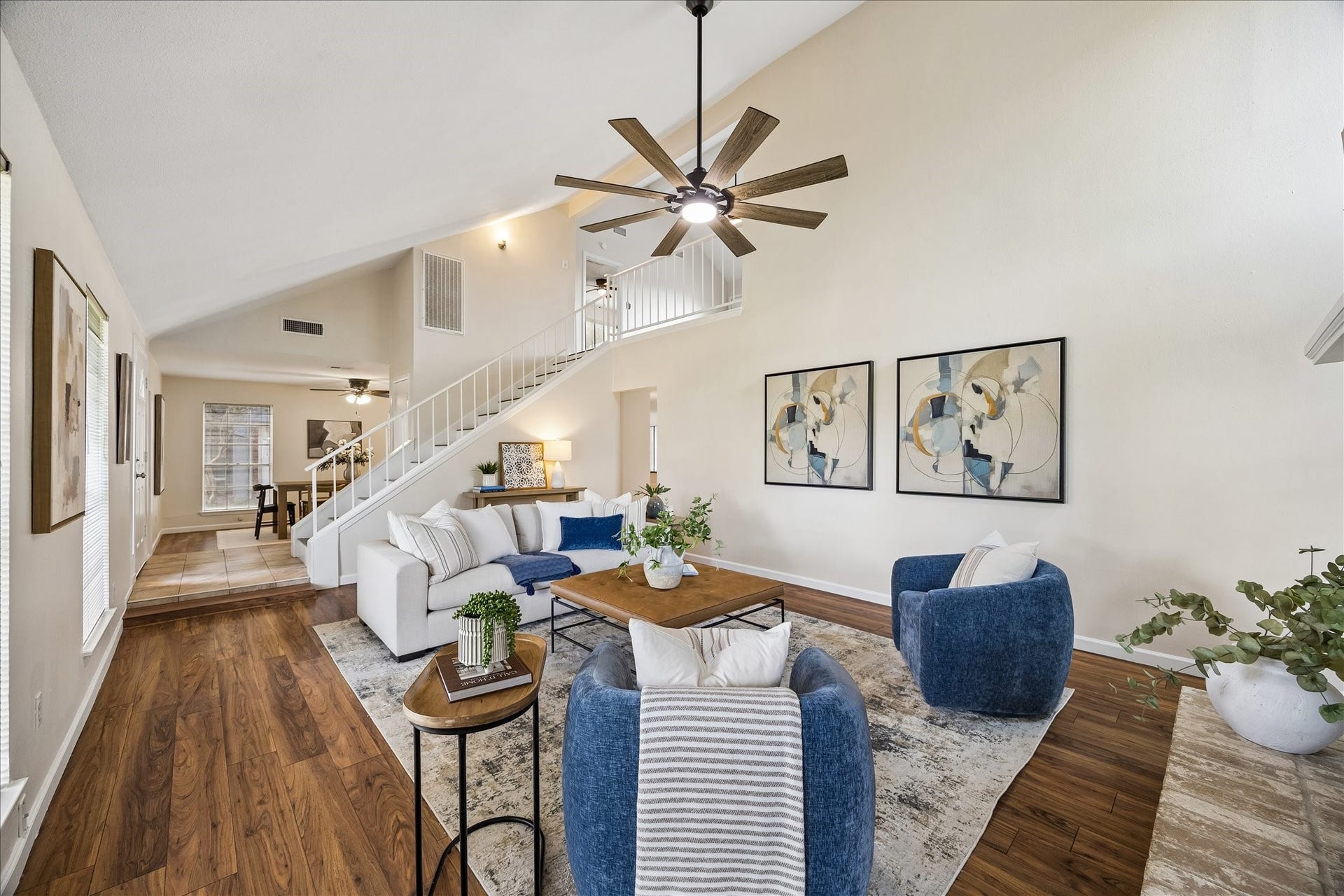 Laminate flooring, soaring ceilings, ceiling fan and natural light. This house is a must see!