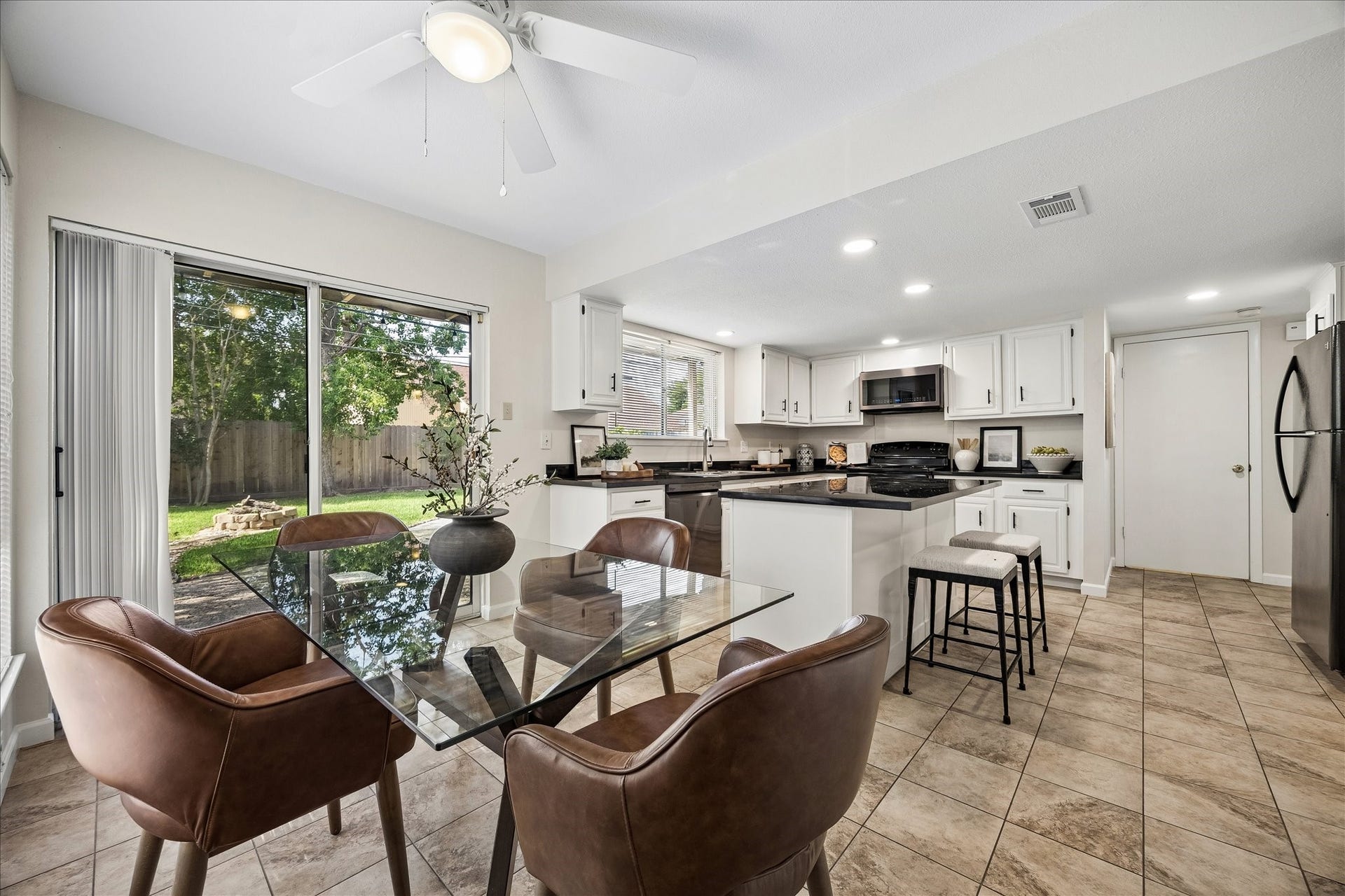 The sliding glass door leads to the patio. The door beyond the kitchen leads to the first floor primary suite.