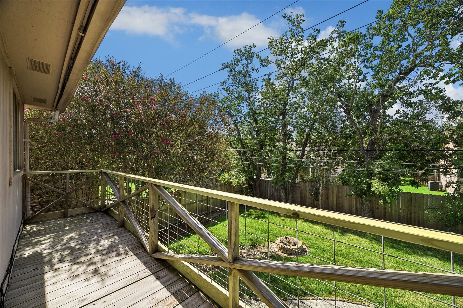 A view from the balcony just off the game room. See the fire pit below and the recent fence.