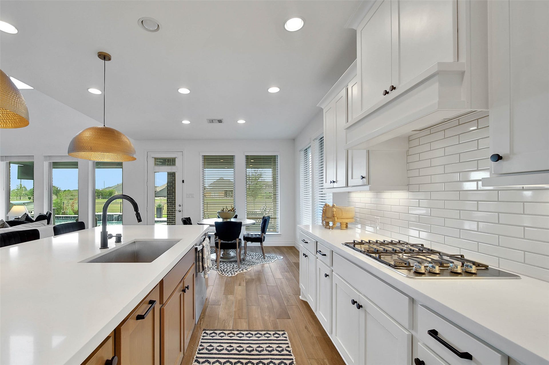 20111 Appaloosa Hill Drive, Tomball, TX 77377 The kitchen also offers crisp white cabinetry, deep SS sink. gas cook top and white subway tile. Updated pendant lights were just added for a decorator's touch!