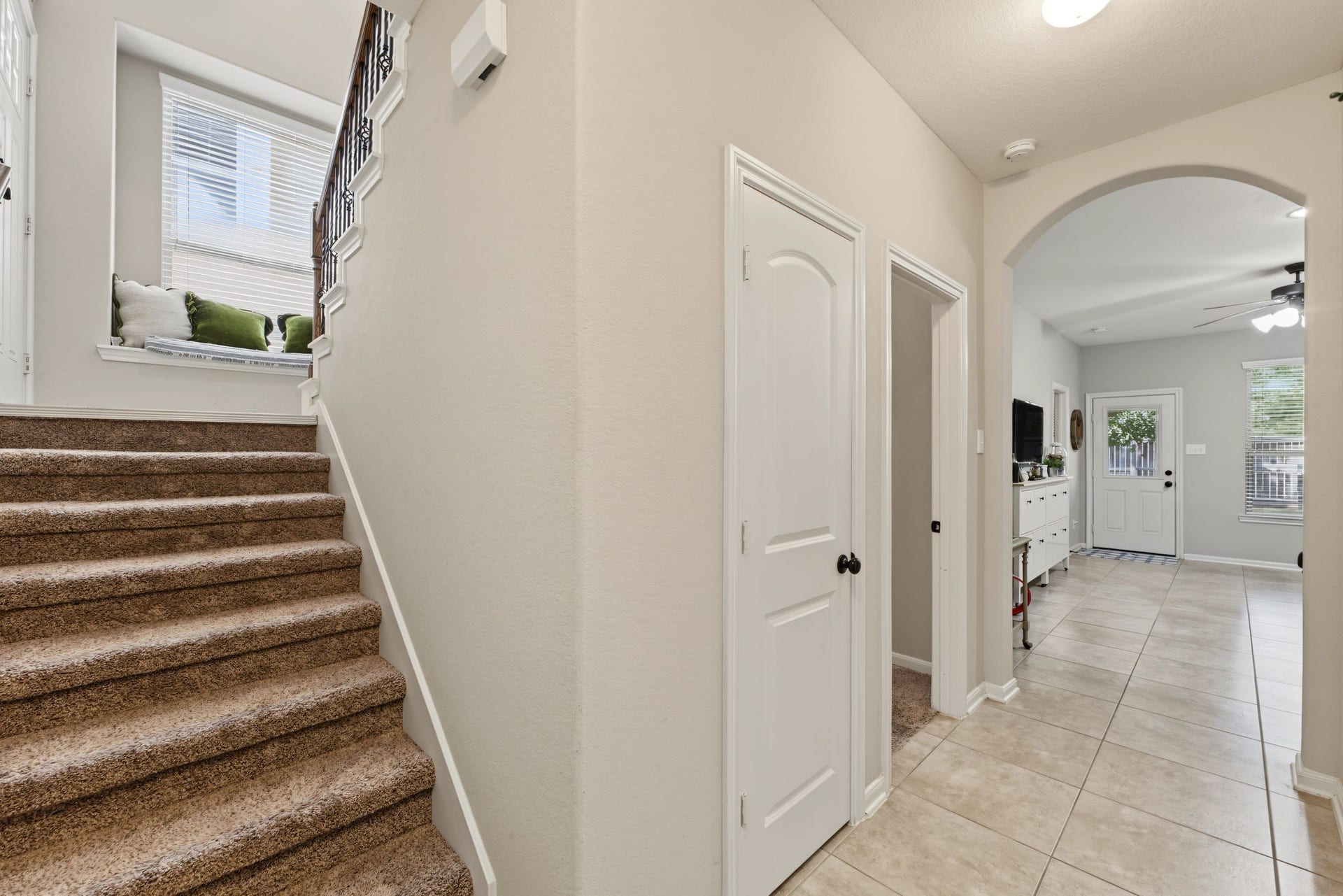 178 Biltmore Loop, Montgomery, TX 77316 A view as you enter the home from the garage (downstairs) You can see storage closet with a hallway leading to the secondary bedrooms and flex space.