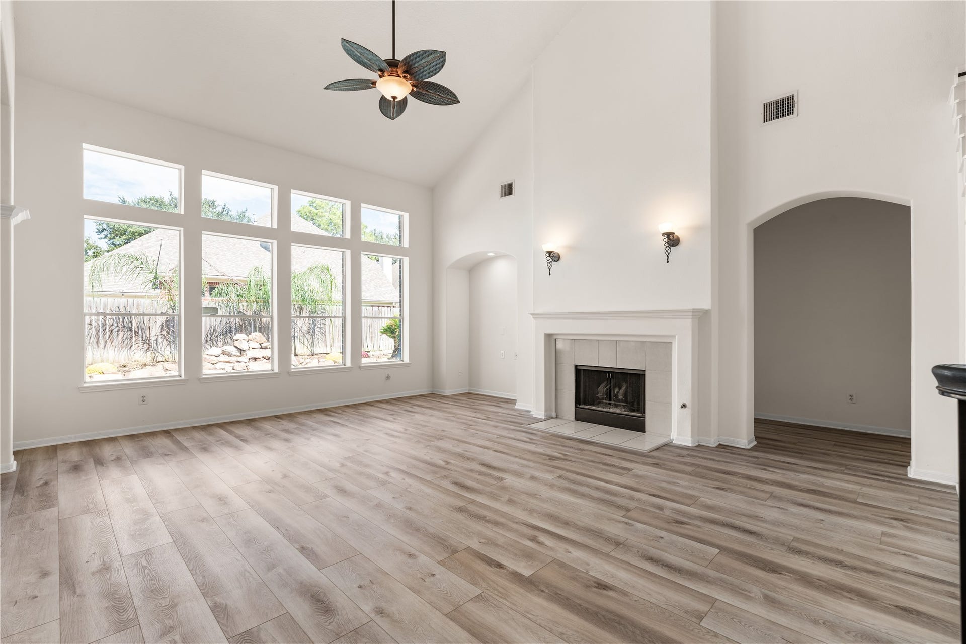23218 Colony Green Drive, Katy, TX 77494 Open concept layout living area with fireplace, high ceilings, and natural light.
