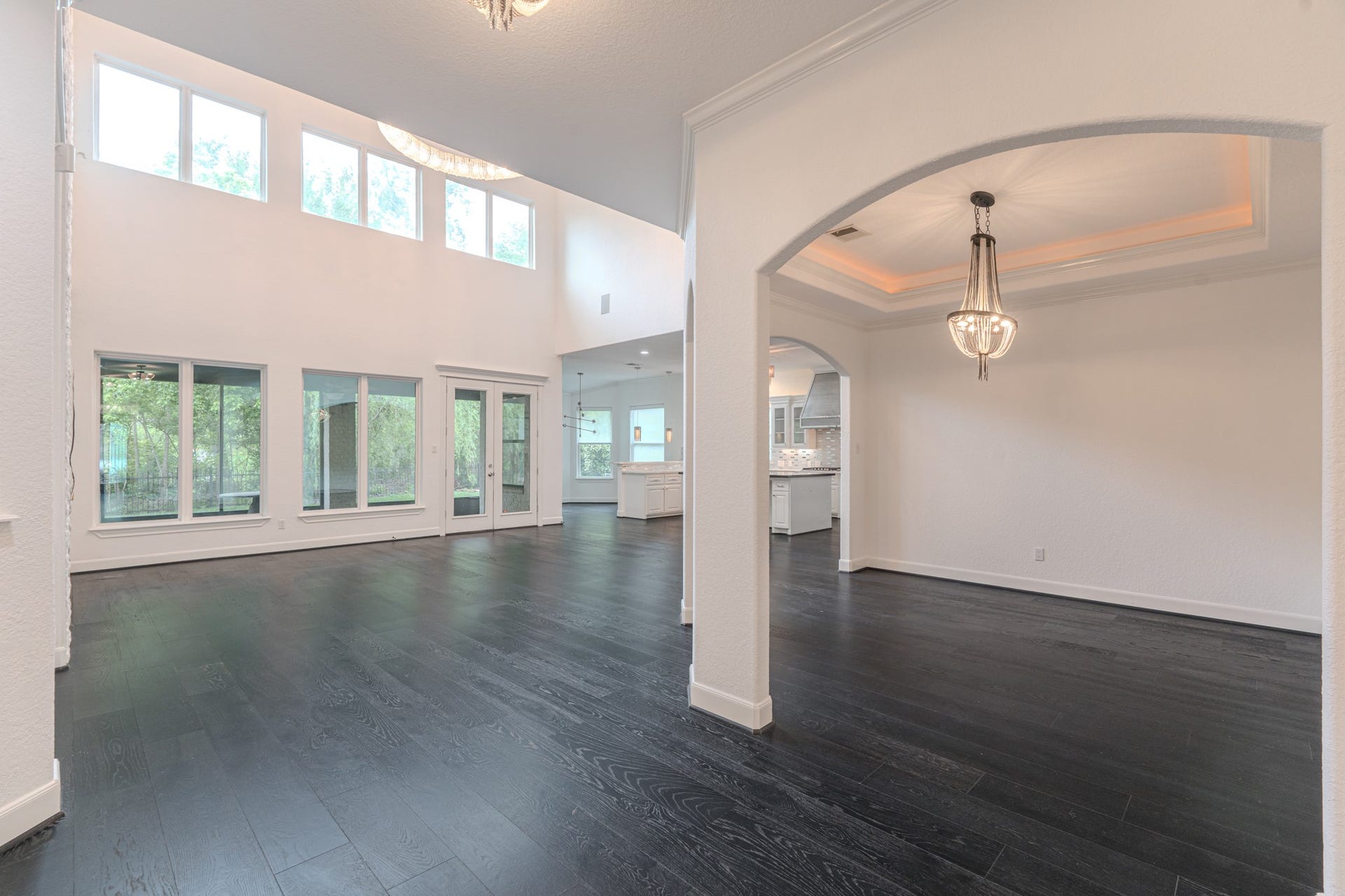 Open living with soaring 2 story ceilings, Formal dinning room with tray ceilings and cove lighting detail.
