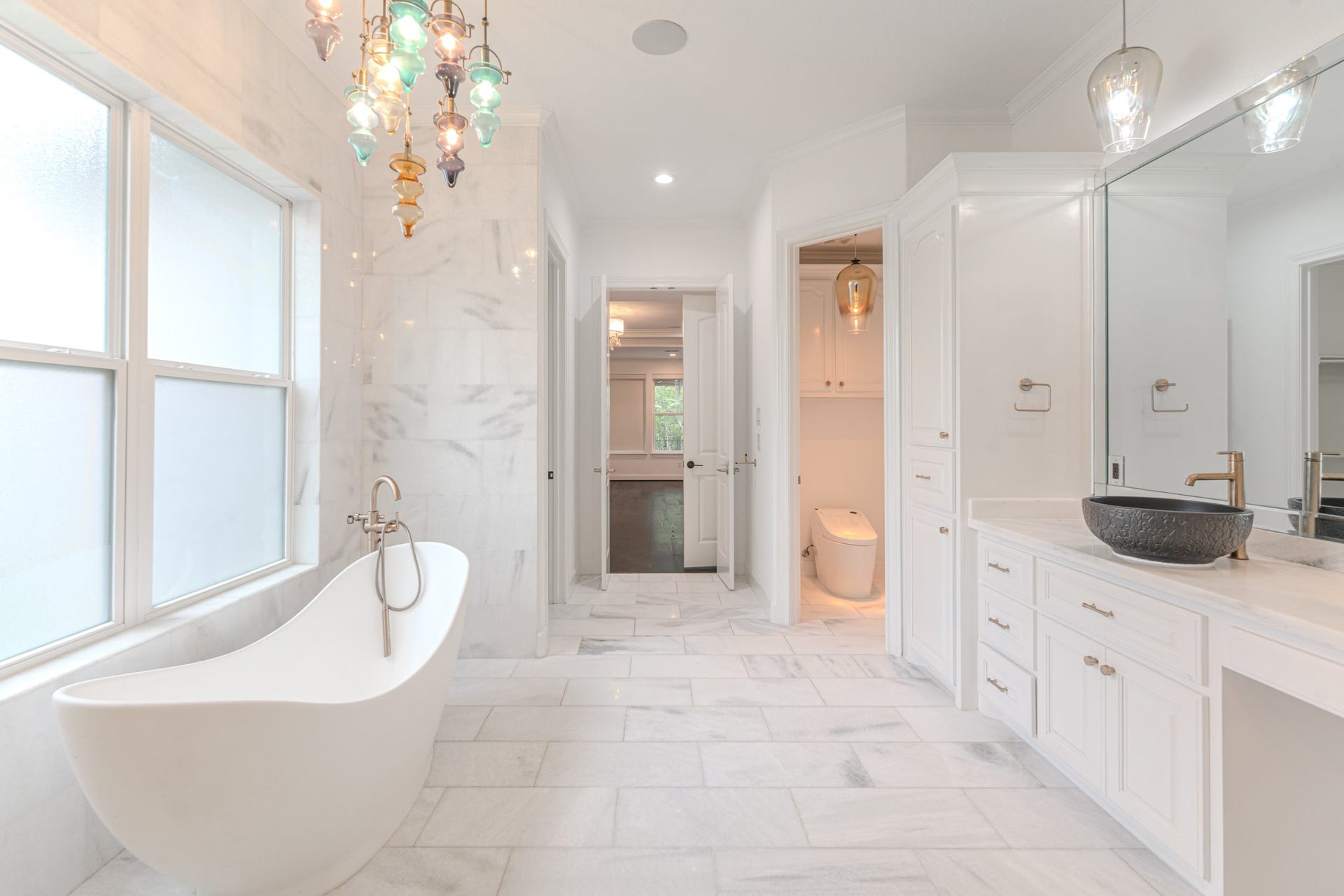 Absolutely beautiful spa like bath with soaking tub, marble floors and walls, separate vanity areas. High end finishes throughout.
