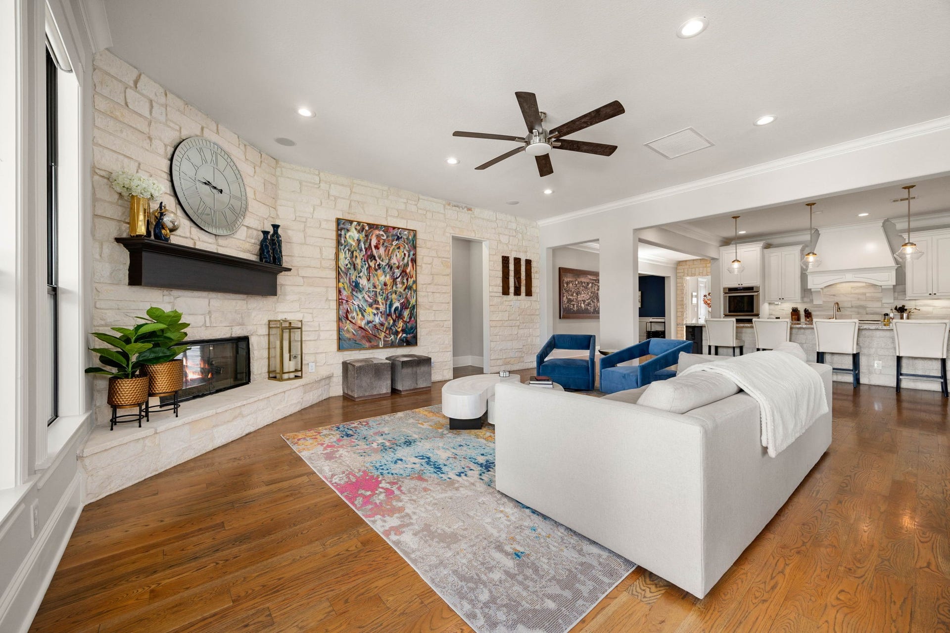 1847 Candlelight Place Drive, Houston, TX 77018 Spacious living area with a cozy stone fireplace, elegant hardwood floors, and an open-concept layout seamlessly leading to a modern kitchen.