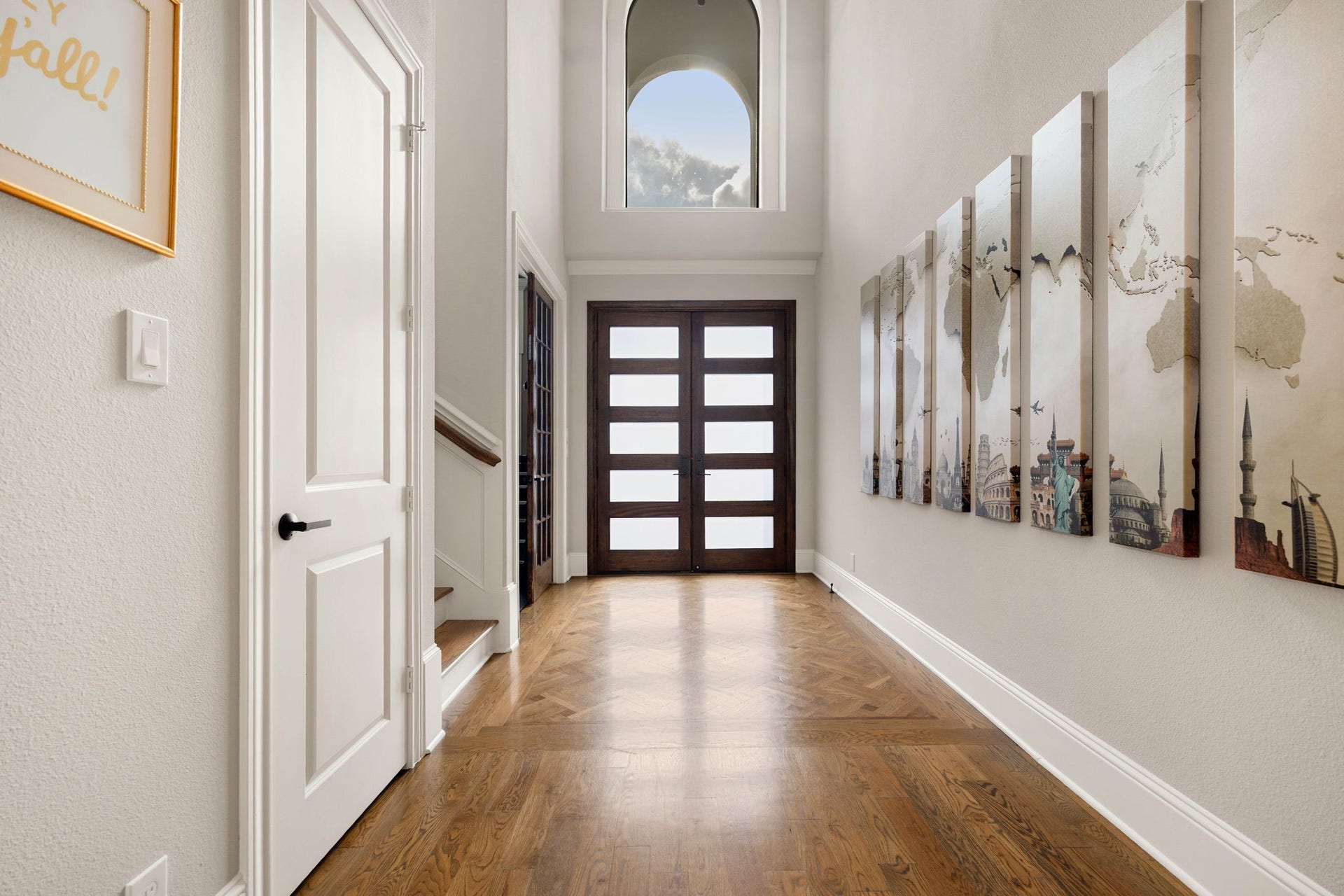 1847 Candlelight Place Drive, Houston, TX 77018 Entry featuring a two-story high ceiling and a modern glass-lite door, complemented by a stunning arched window at the top of the entrance.