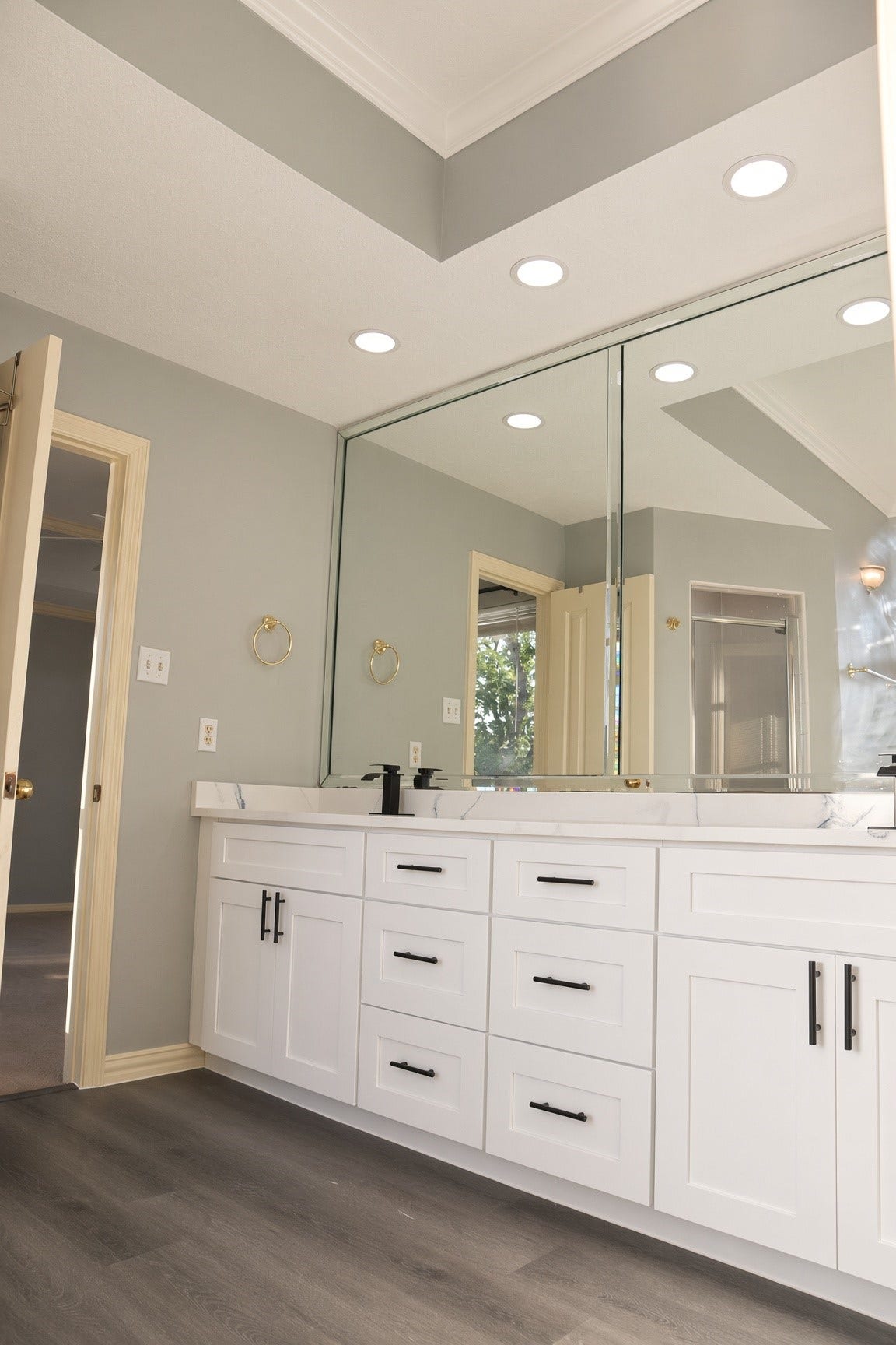 114 Oyster Creek Drive, Sugar Land, TX 77478 Spacious bathroom featuring a large vanity with ample storage, sleek white cabinetry, and elegant fixtures, complemented by mirrors and recessed lighting.