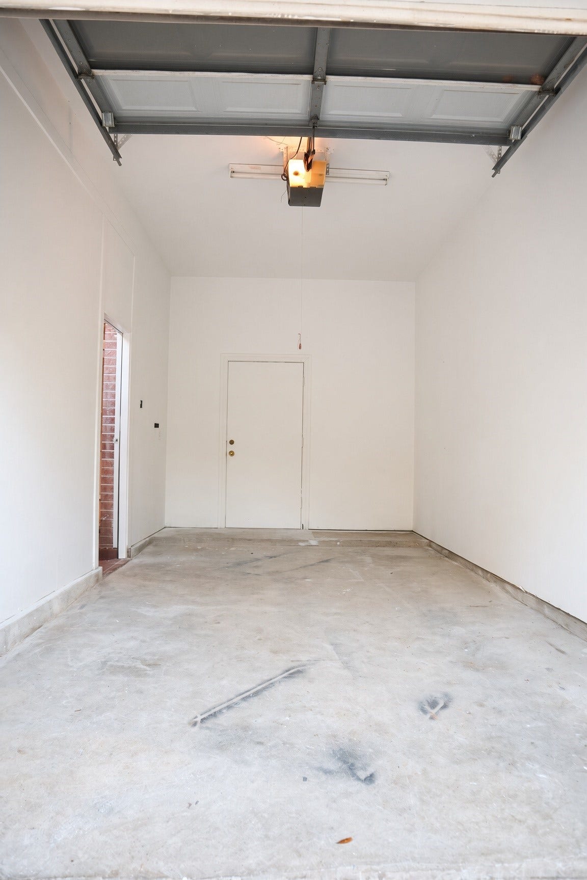 114 Oyster Creek Drive, Sugar Land, TX 77478 Spacious single-car garages with high ceiling, offering plenty of room for storage and easy vehicle access.