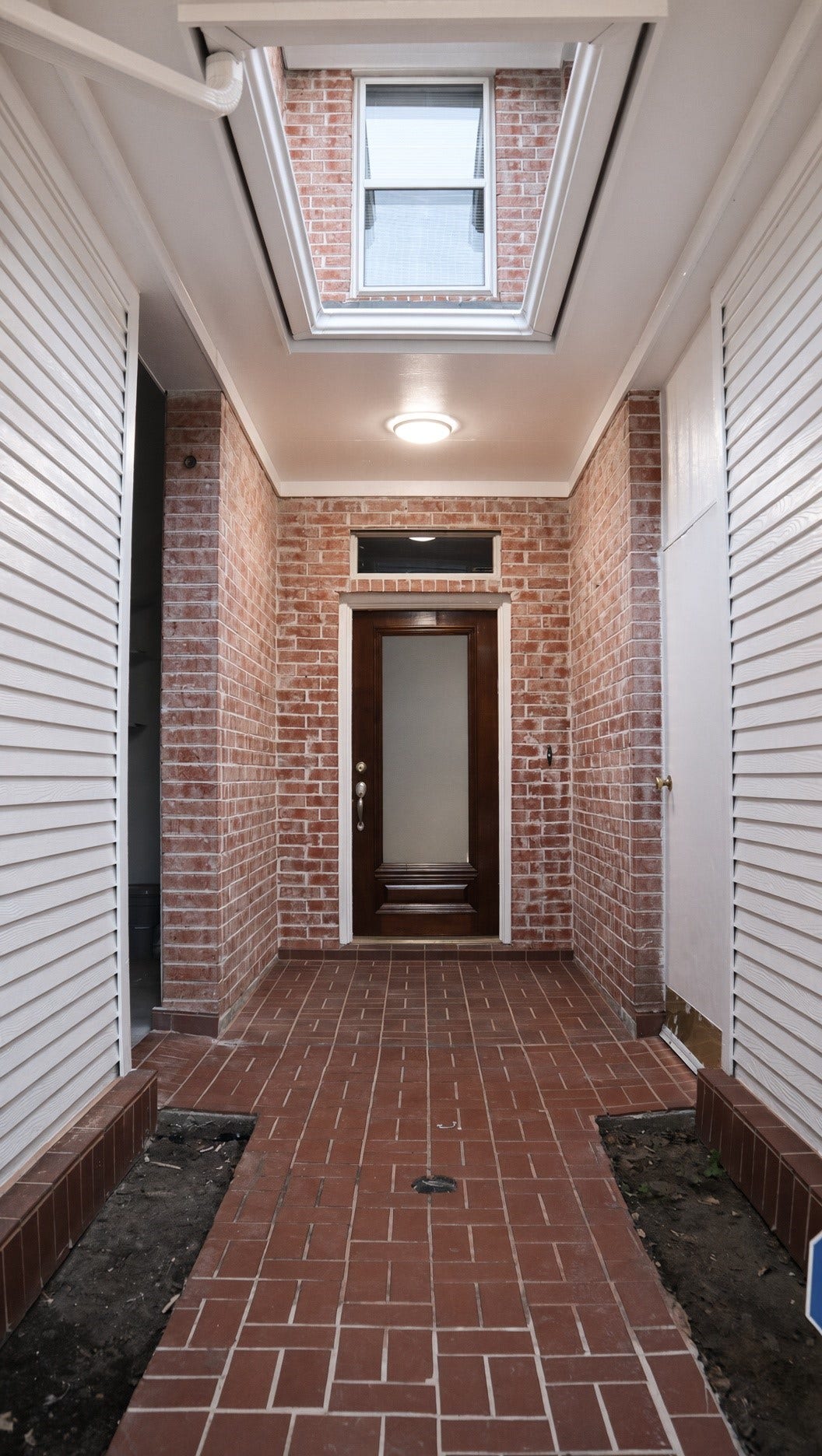 114 Oyster Creek Drive, Sugar Land, TX 77478 Charming brick entryway, leading to a welcoming wooden door.