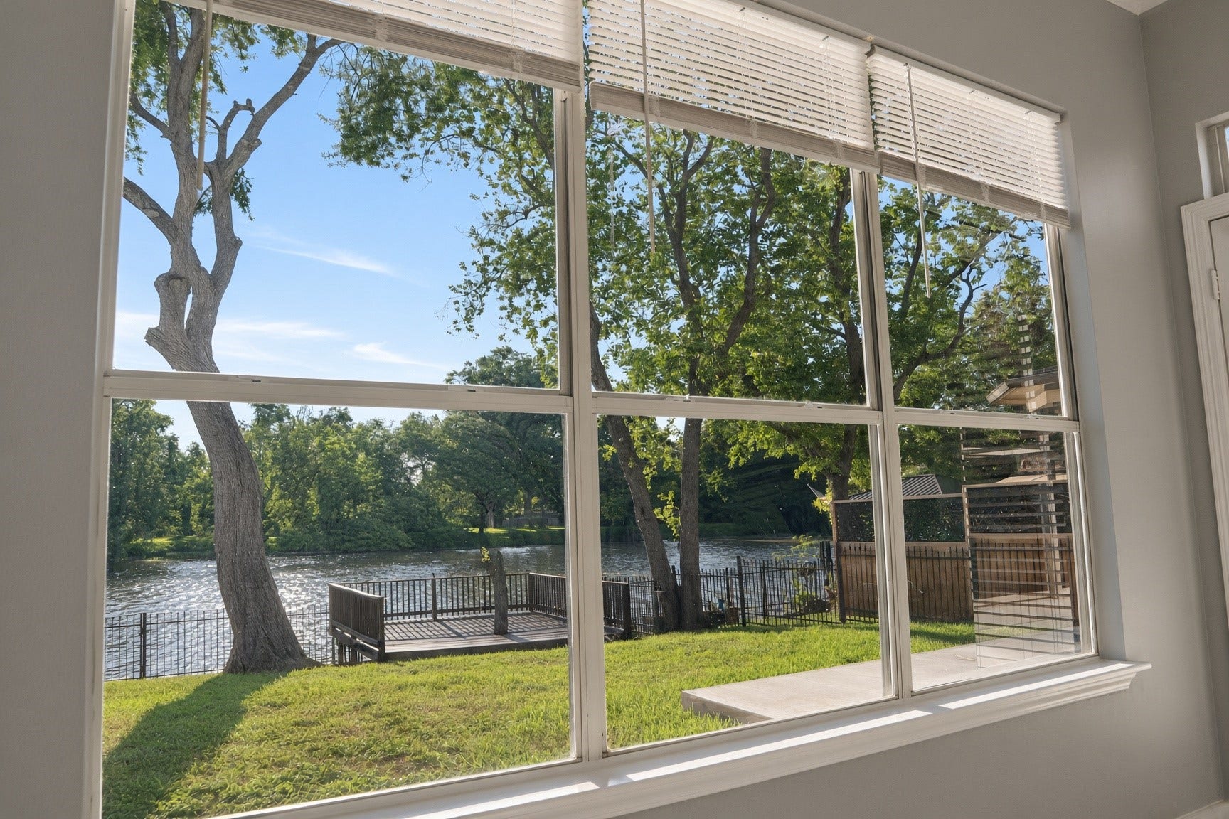 114 Oyster Creek Drive, Sugar Land, TX 77478 Enjoy serene water views through expansive windows, offering a perfect blend of indoor comfort and outdoor beauty.