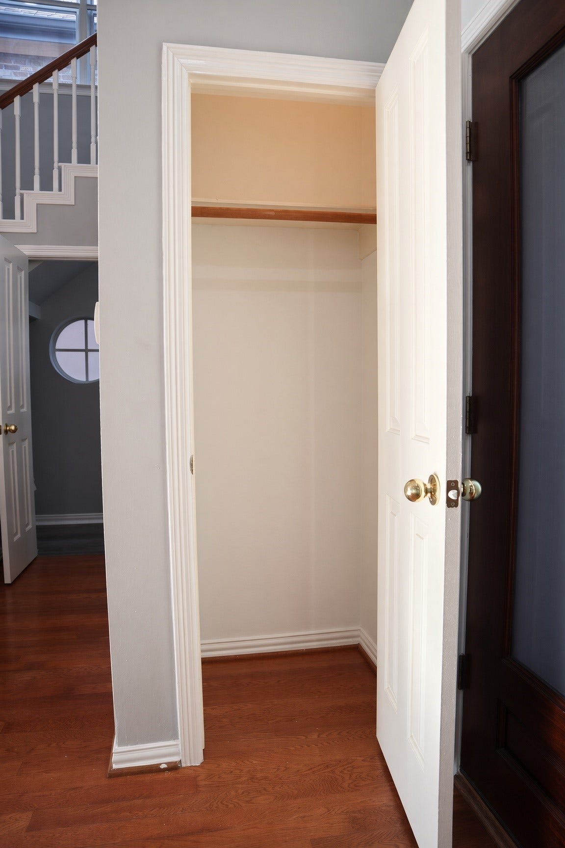 114 Oyster Creek Drive, Sugar Land, TX 77478 Charming entryway with a convenient coat closet, featuring hardwood flooring and elegant stairway details.