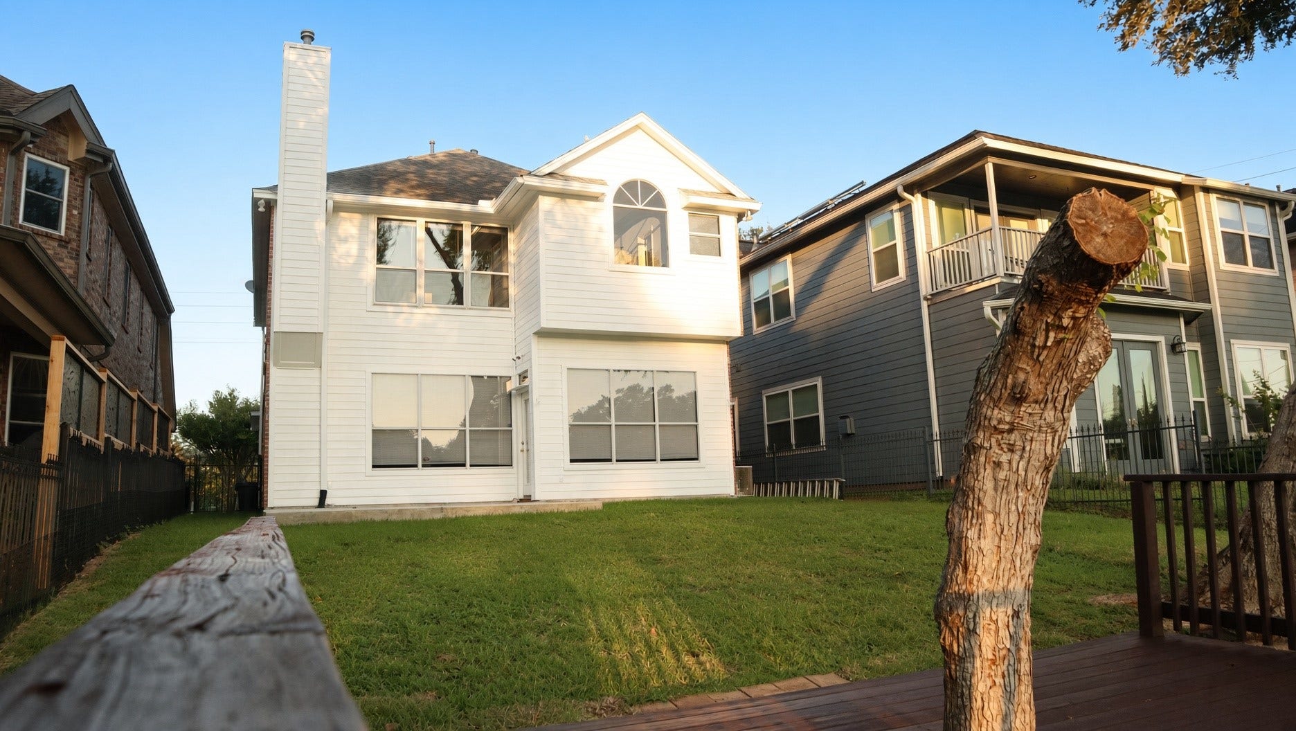 114 Oyster Creek Drive, Sugar Land, TX 77478 Charming two-story home with a bright white exterior, expansive windows, and a spacious backyard, great for outdoor activities.