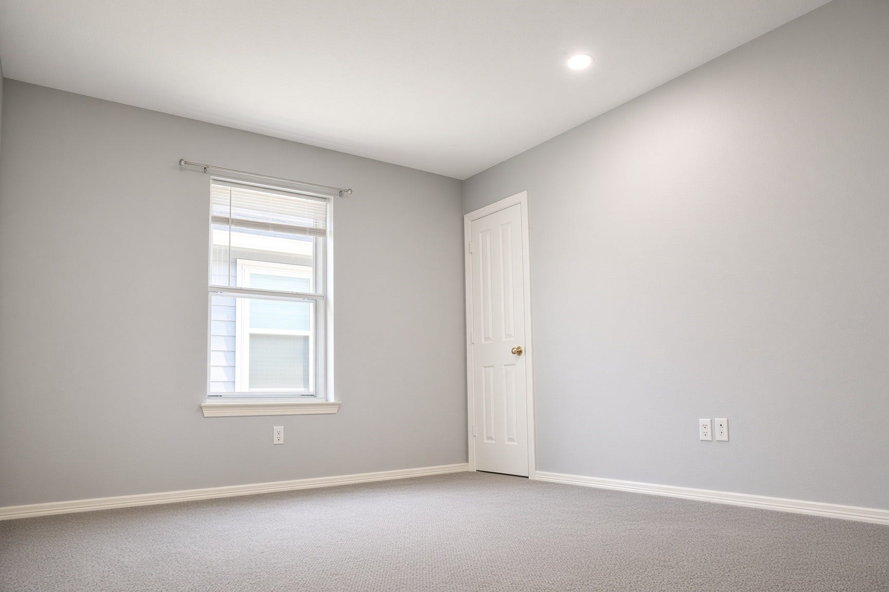 114 Oyster Creek Drive, Sugar Land, TX 77478 Cozy bedroom with soft gray walls, plush carpeting, and a single window letting in natural light.