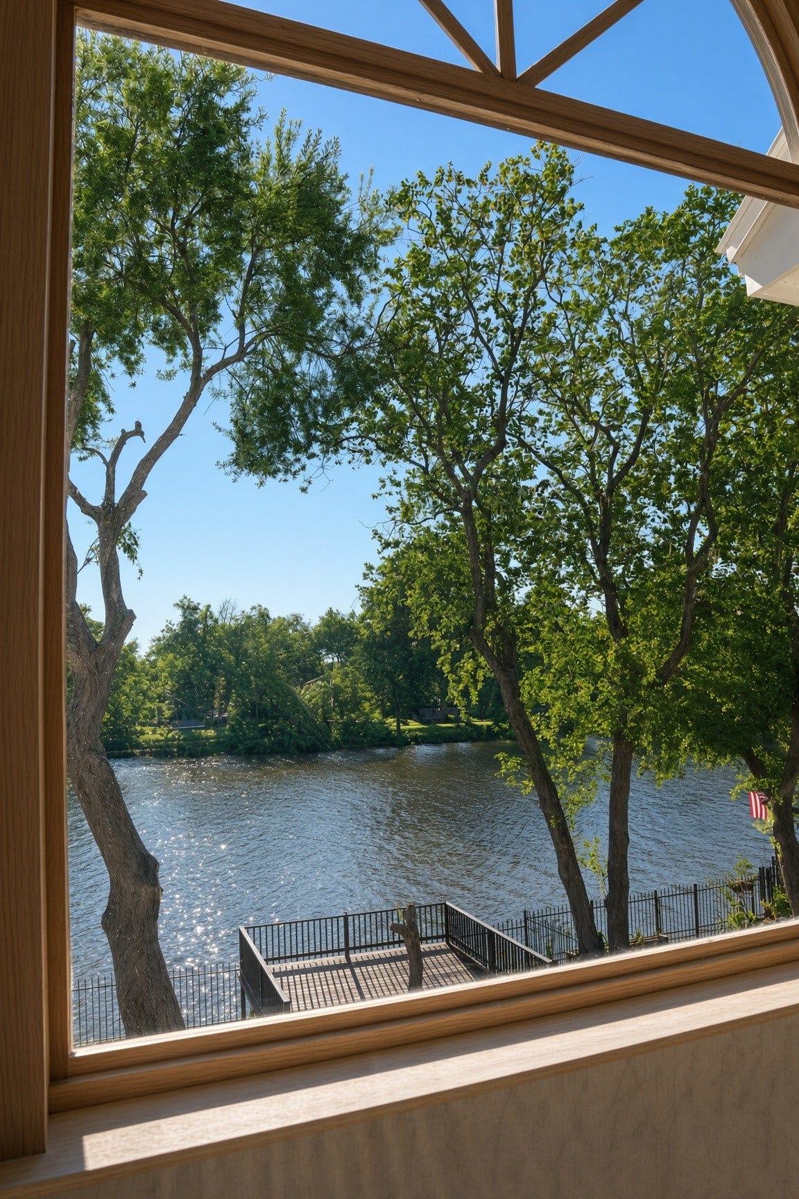 114 Oyster Creek Drive, Sugar Land, TX 77478 Enjoy serene water views framed by lush trees from this inviting window, offering a perfect blend of nature and tranquility.