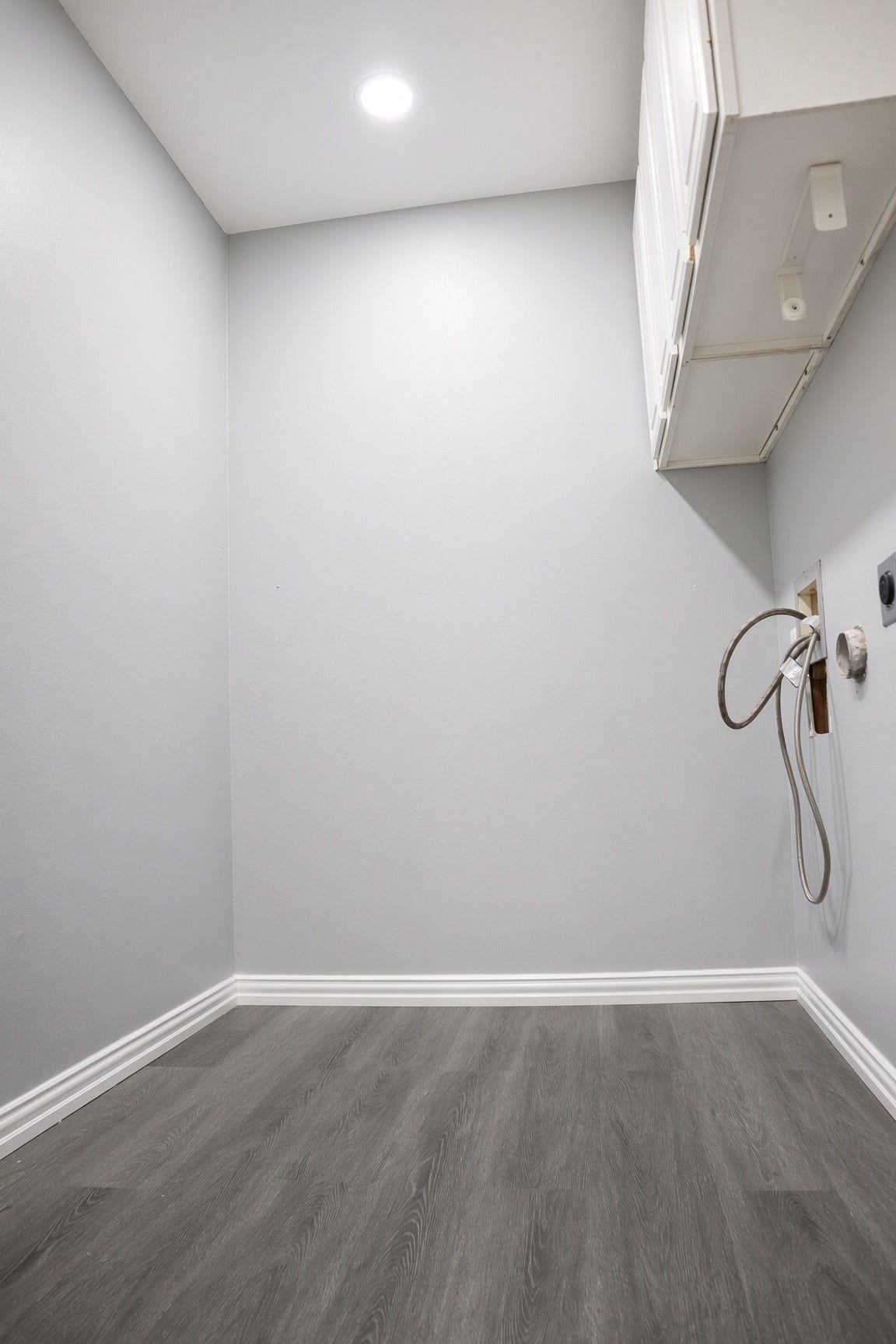 114 Oyster Creek Drive, Sugar Land, TX 77478 Spacious laundry room with sleek gray walls, modern cabinetry, and hookups ready for appliances.