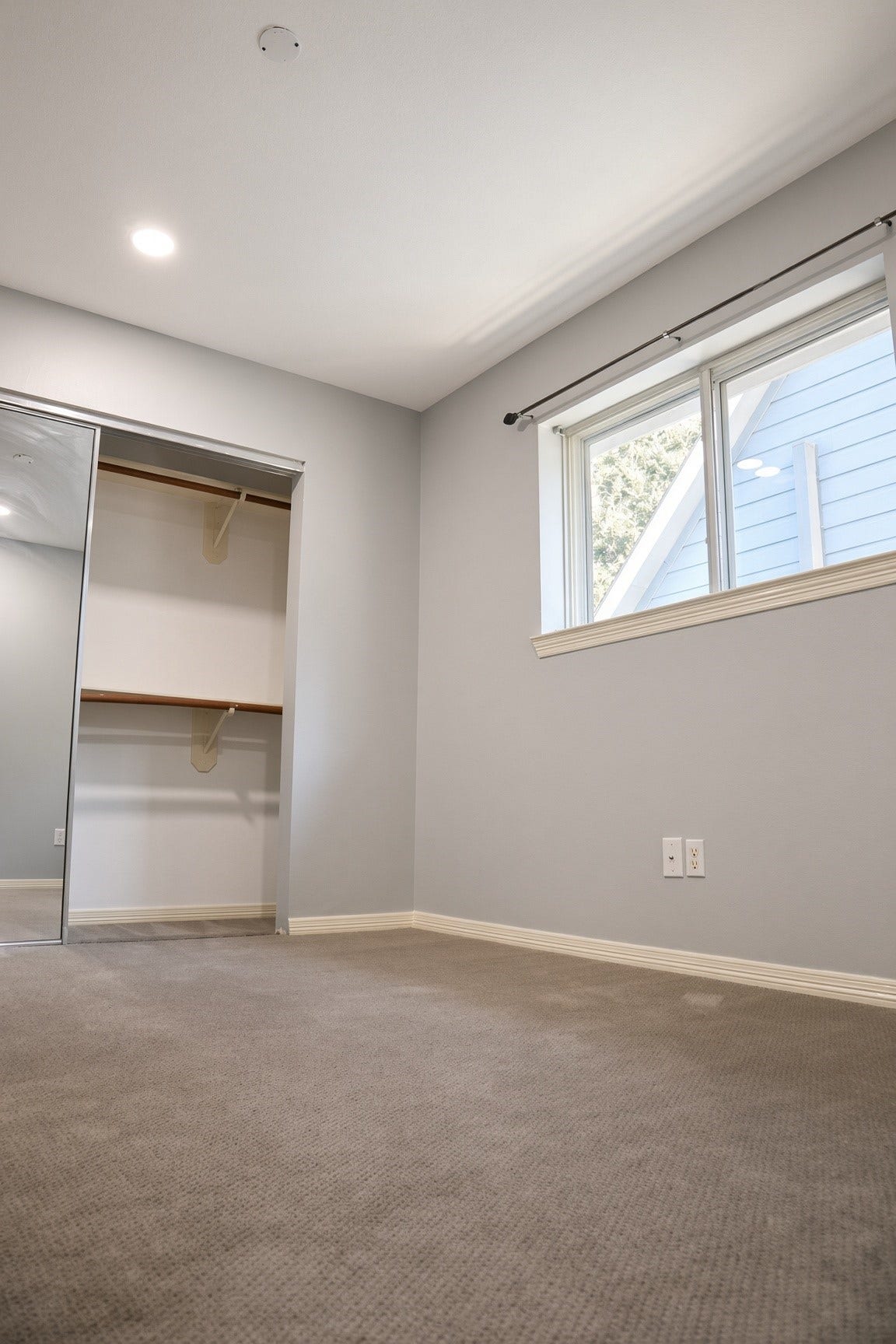 114 Oyster Creek Drive, Sugar Land, TX 77478 Bright and cozy bedroom featuring plush carpet, a large window for natural light, and a mirrored closet for ample storage.