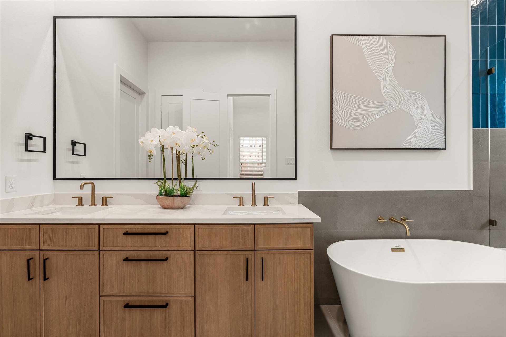 4615 Buck Street, Houston, TX 77020 Dual undermount vanity area equipped with warm brass hardware and soft-close storage.