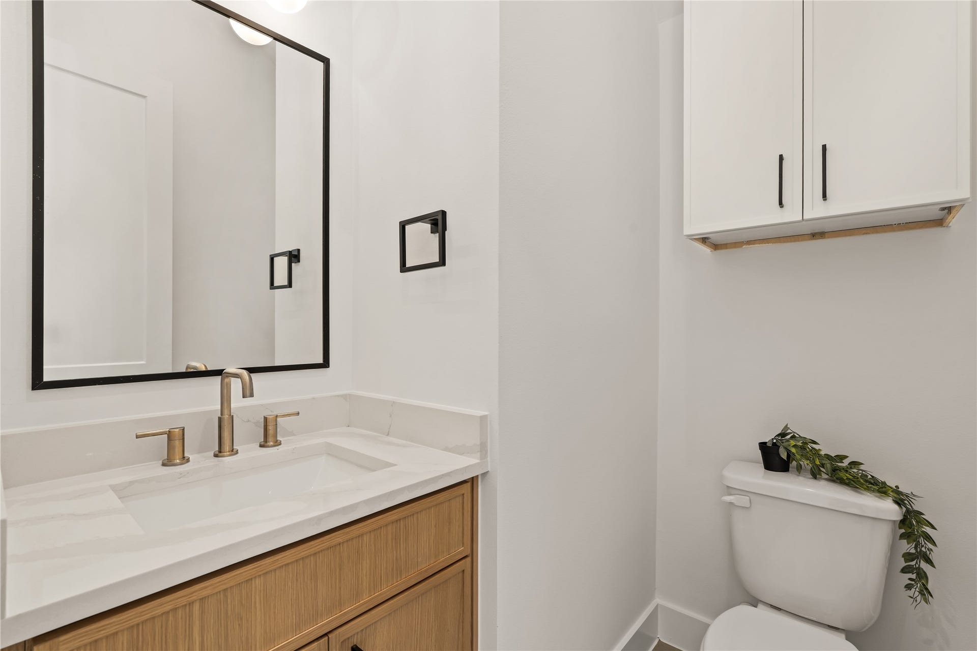 4615 Buck Street, Houston, TX 77020 Convenient main-floor powder room complete with modern fixtures and a warm wood vanity.