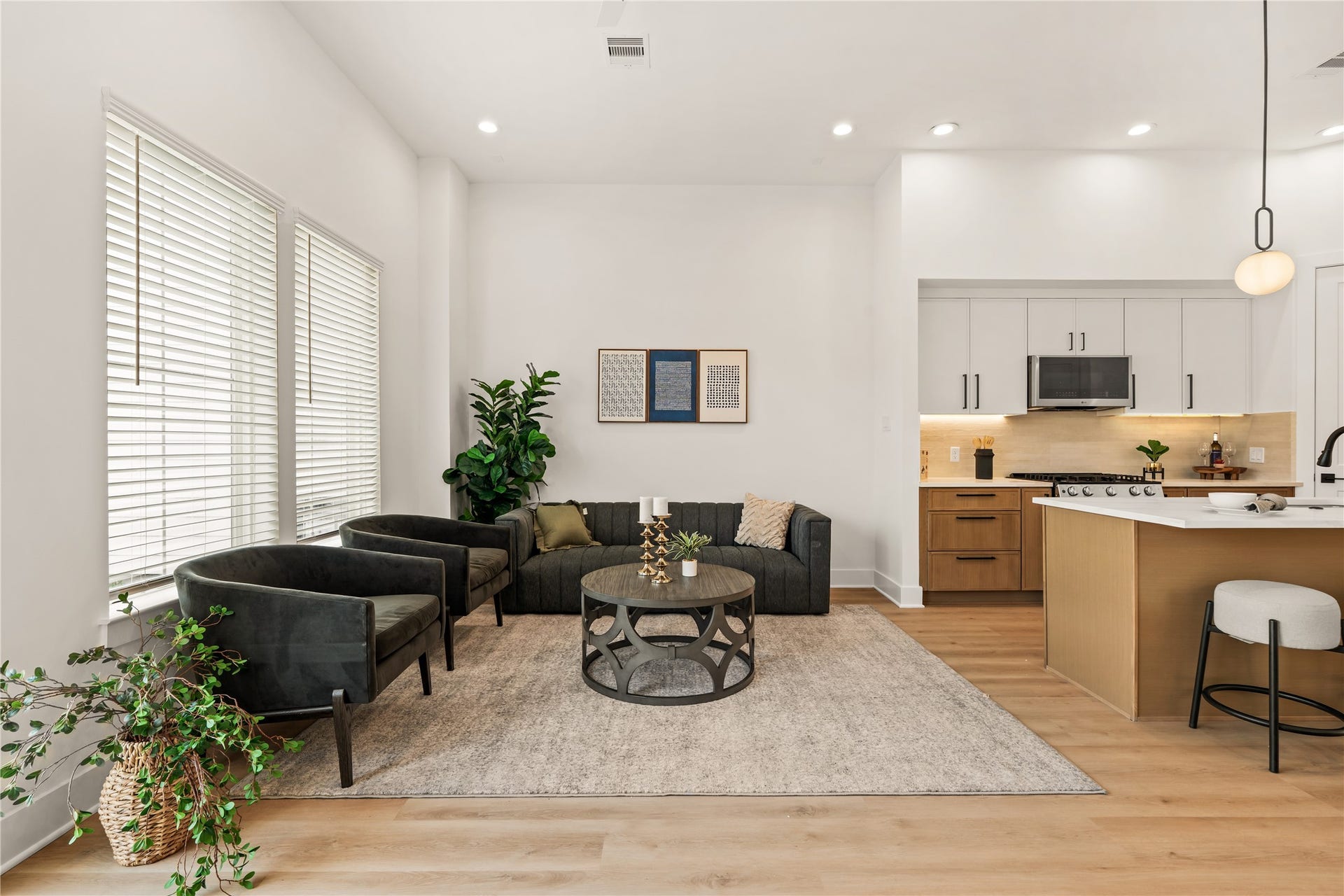 4615 Buck Street, Houston, TX 77020 Spacious family room anchored by warm wood-look flooring and sunlit windows.