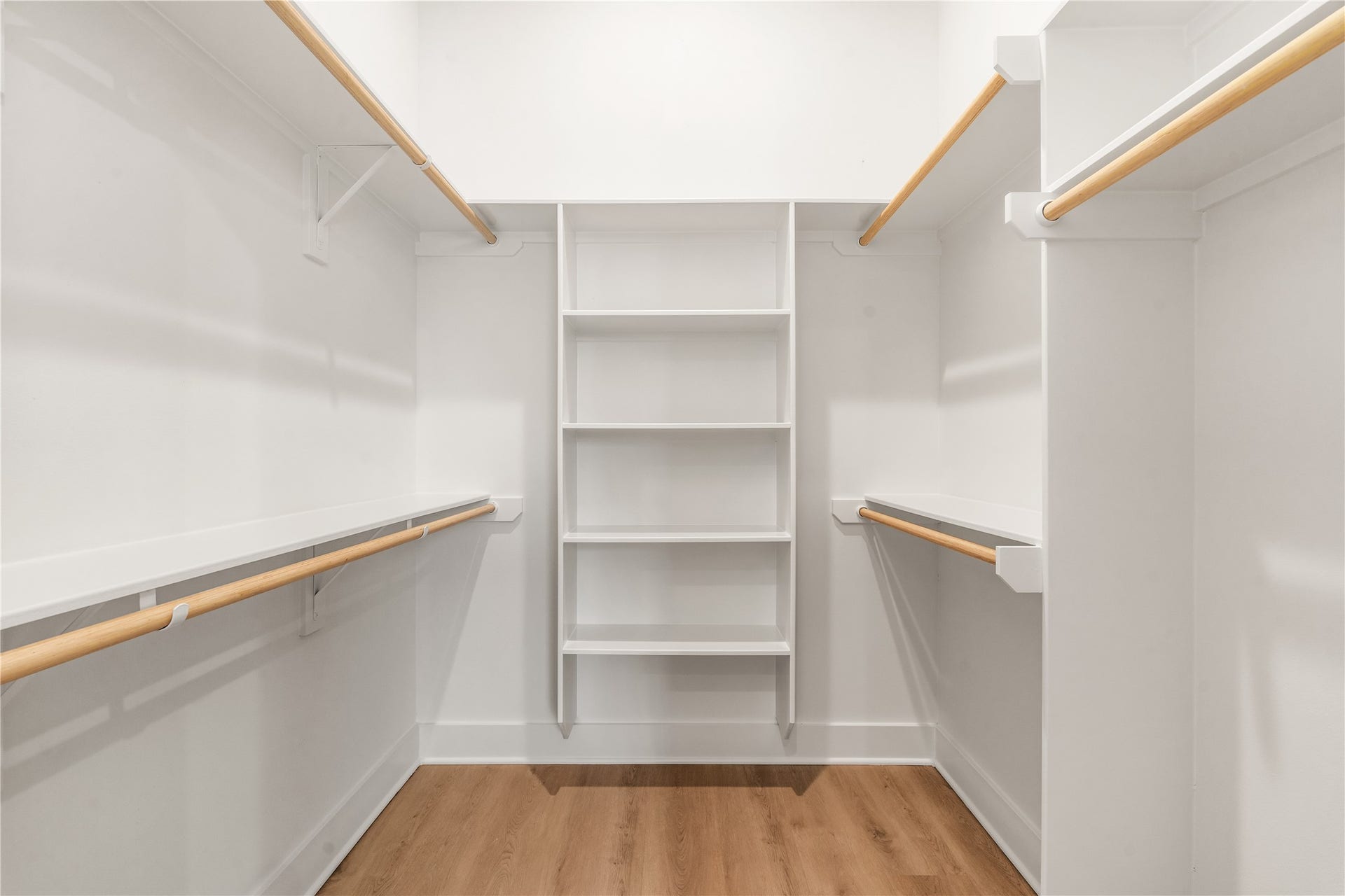 4615 Buck Street, Houston, TX 77020 Custom walk-in primary closet featuring built-in shelving and dual hanging rods.