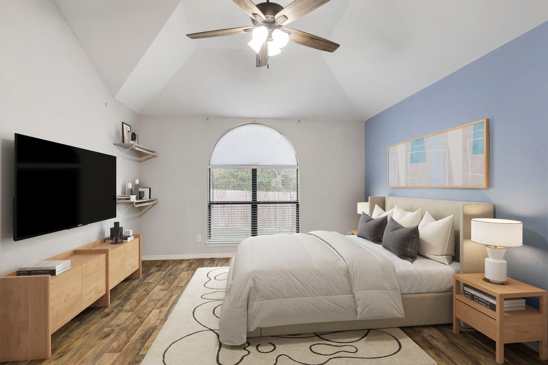 8022 N Tarrytown Crossing Drive, Conroe, TX 77304 Experience serene luxury in this spacious primary bedroom, featuring vaulted ceilings, elegant wood flooring, and a soothing color palette, perfect for relaxation and comfort.