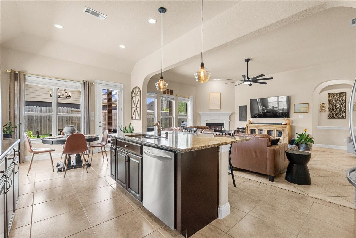 1413 Coffee Mill Court, League City, TX 77573 The chef-inspired kitchen with 42" cabinetry, crown molding, granite countertops, designer backsplash, stainless steel appliances, walk-in pantry, and butlers pantry.