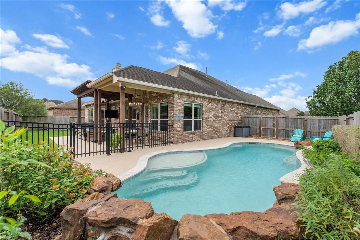 1413 Coffee Mill Court, League City, TX 77573 Step outside to your private backyard oasis featuring a sparkling pool, extended patio perfect for entertaining, and plenty of additional yard space for the kids to play.